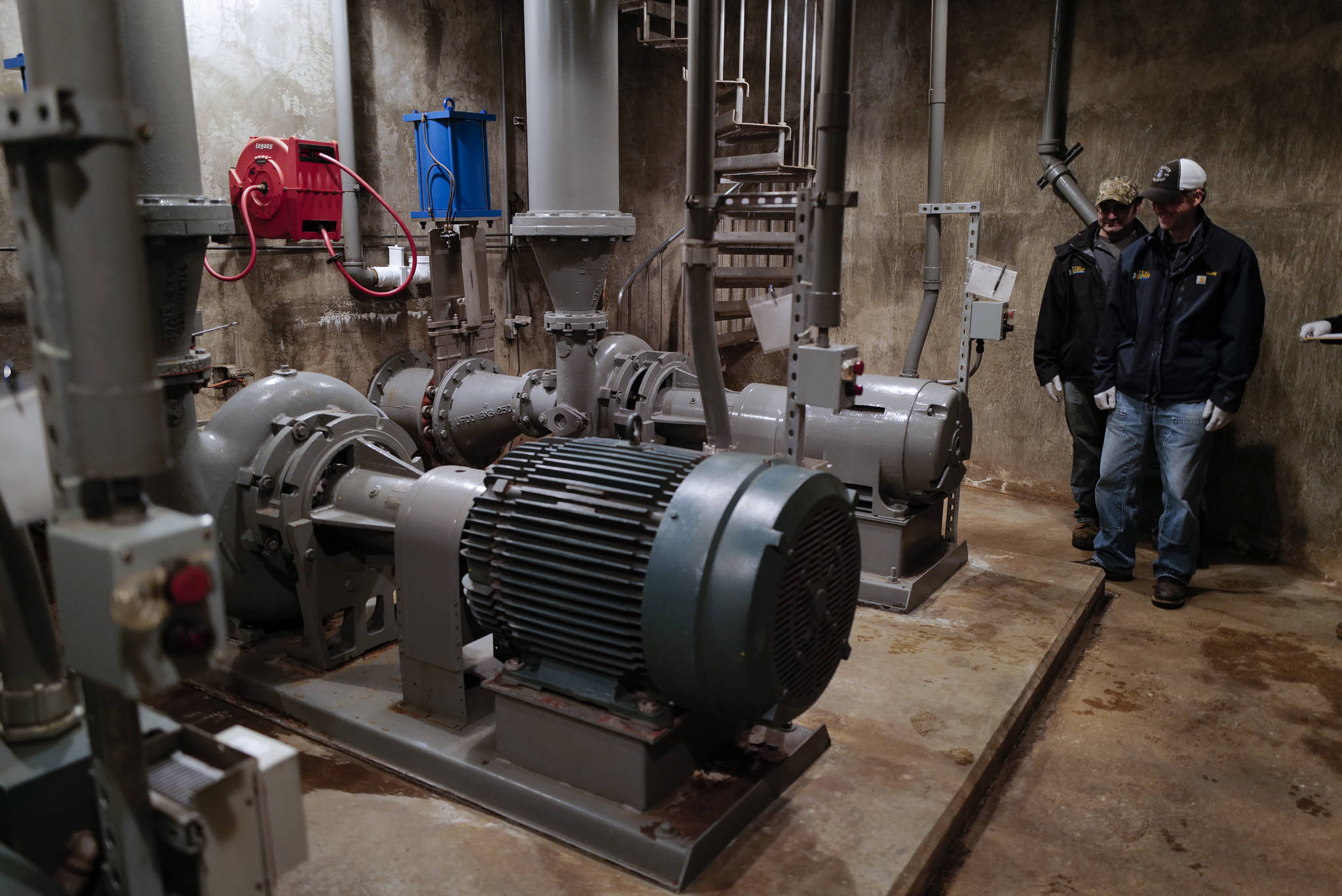 Otto Dunayski, left, and Scott Simonson, senior wastewater collection officers for the city, inspect three pumps three-story underground at the Outer Drive Pumping Station downtown on Friday, Oct. 11, 2019. The pumps were overwhelmed during last weekend’s storm that caused a backup of sewage into the Mayor Bill Overstreet Park utilities building. (Michael Penn | Juneau Empire)