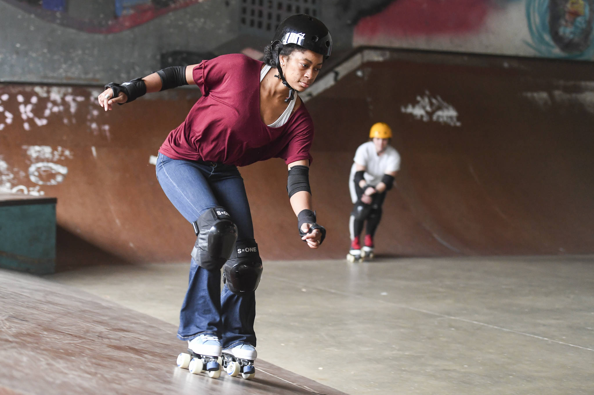 Jennifer Gross, left, and Shabadrang Khalsa, who skate with the Juneau Rollergirls, get their daily skate in at the Pipeline Skate Park on Friday, Oct. 11, 2019. The two are skating every day as part of a challenge to every day for a year. (Michael Penn | Juneau Empire)