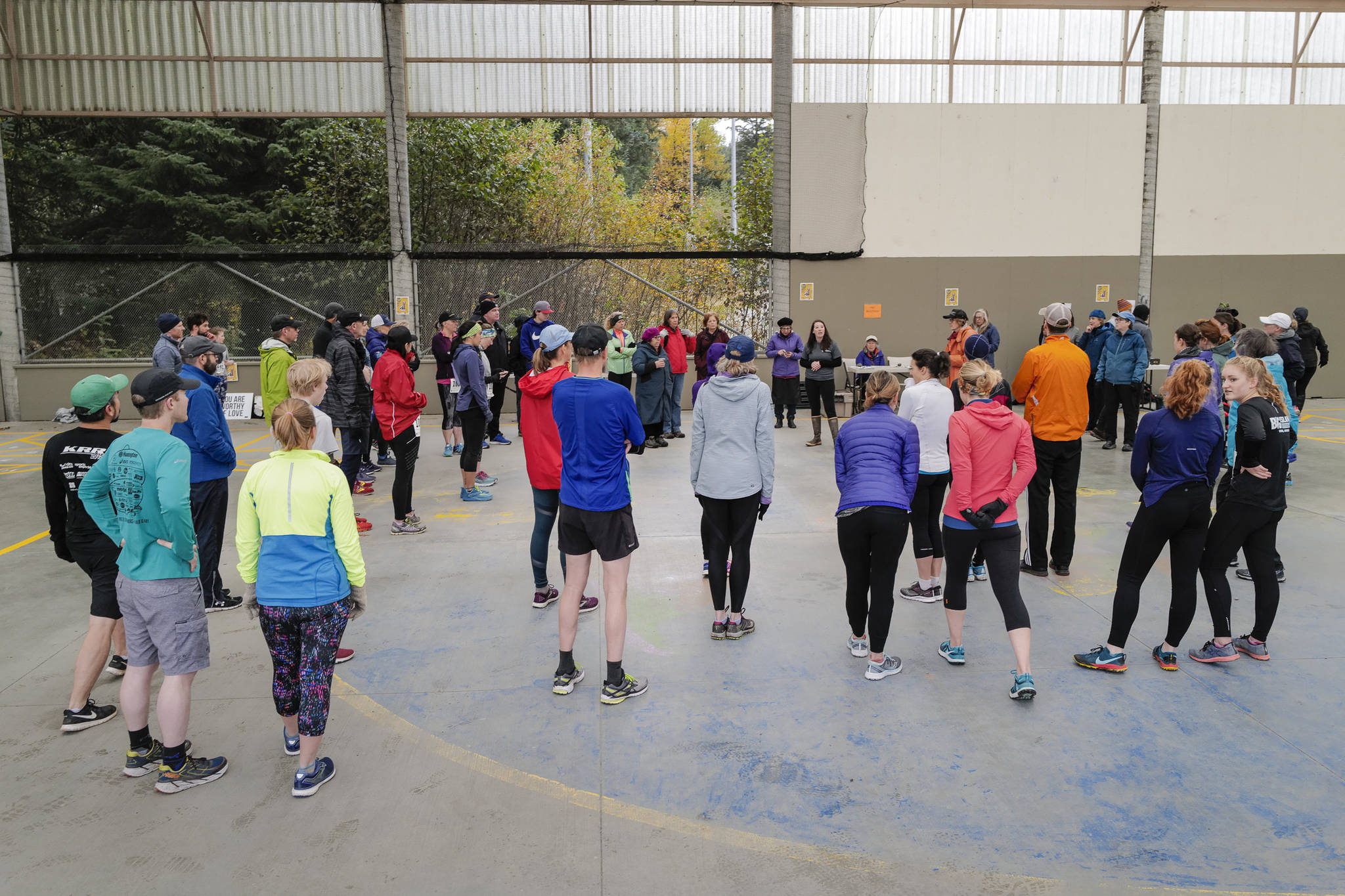 Juneau residents gather for pre-race instructions before the annual community mental health run, the Extra Tough 5K & 1 Mile Run, on Saturday, Oct. 12, 2019, at Riverbend Elementary School. The run is sponsored by National Alliance on Mental Illness (NAMI) Juneau. (Michael Penn | Juneau Empire)