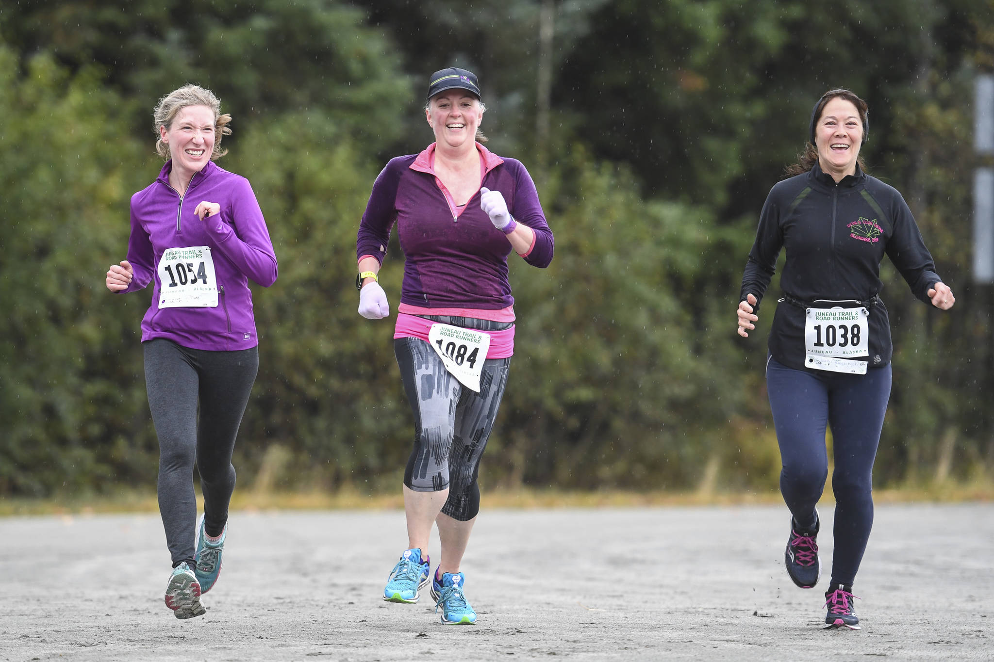 Tisha Gieser, left, Ruth Kostik, center, and Joann Rieselbach near the finish at the annual community mental health run, the Extra Tough 5K & 1 Mile Run, on Saturday, Oct. 12, 2019, at Riverbend Elementary School. The run is sponsored by National Alliance on Mental Illness (NAMI) Juneau. (Michael Penn | Juneau Empire)