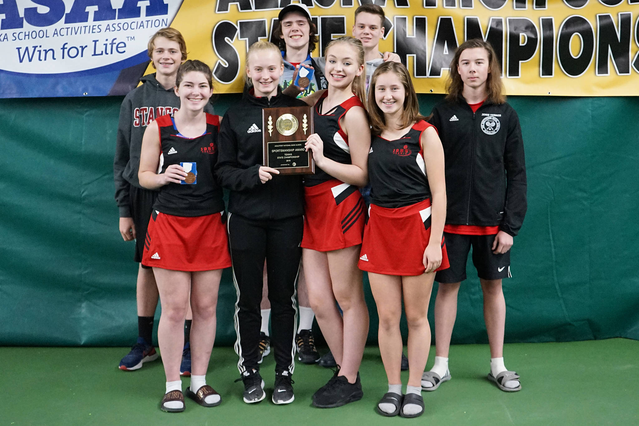 The Juneau-Douglas High School: Yadaat.at Kale tennis team poses with its sportsmanship award at the ASAA tennis state championships in Anchorage on Saturday, Oct. 11, 2019. Back row (L to R) Will Rehfeldt, William Smoker, Kevin Kooistra, Liam Penn. Front row: Olivia Moore, Anna Dale, Jaymie Collman, Adelie McMillan. (Courtesy Photo | Kurt Dzinich)