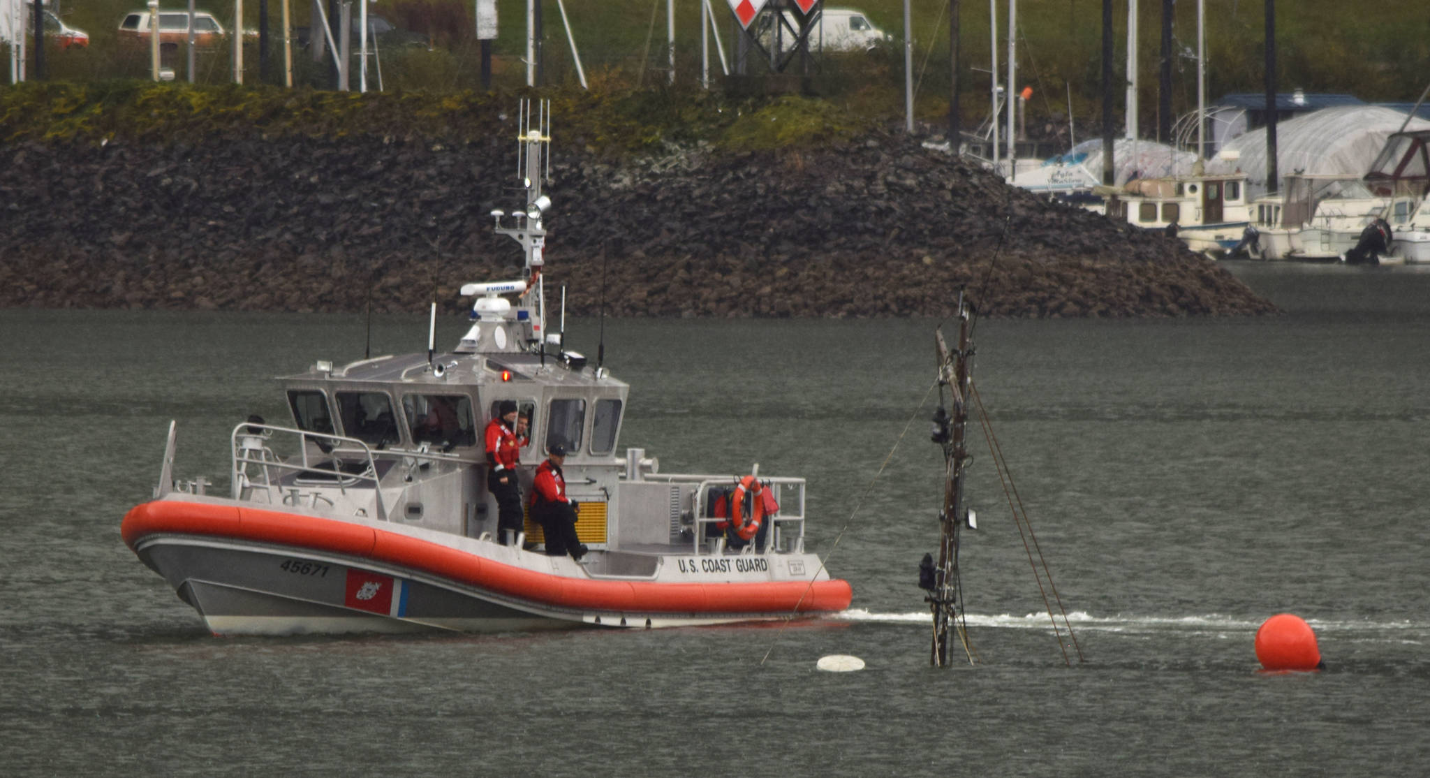 A U.S. Coast Guard Station Juneau small-boat crew examines the mast of the sunken 94-foot tugboat Challenger, Sept. 12, 2015 in Gastineau Channel. (Michael Penn | Juneau Empire File)