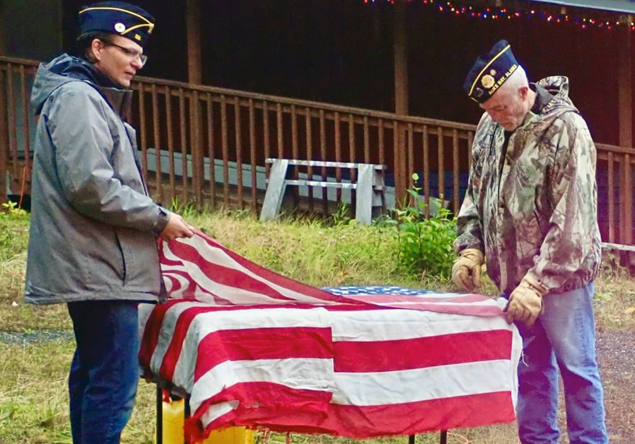 First Vice Commander Ryan Brown, left, and Commander John Cooper prepare a flag for disposal on Saturday, Oct. 12. (Courtesy photo)