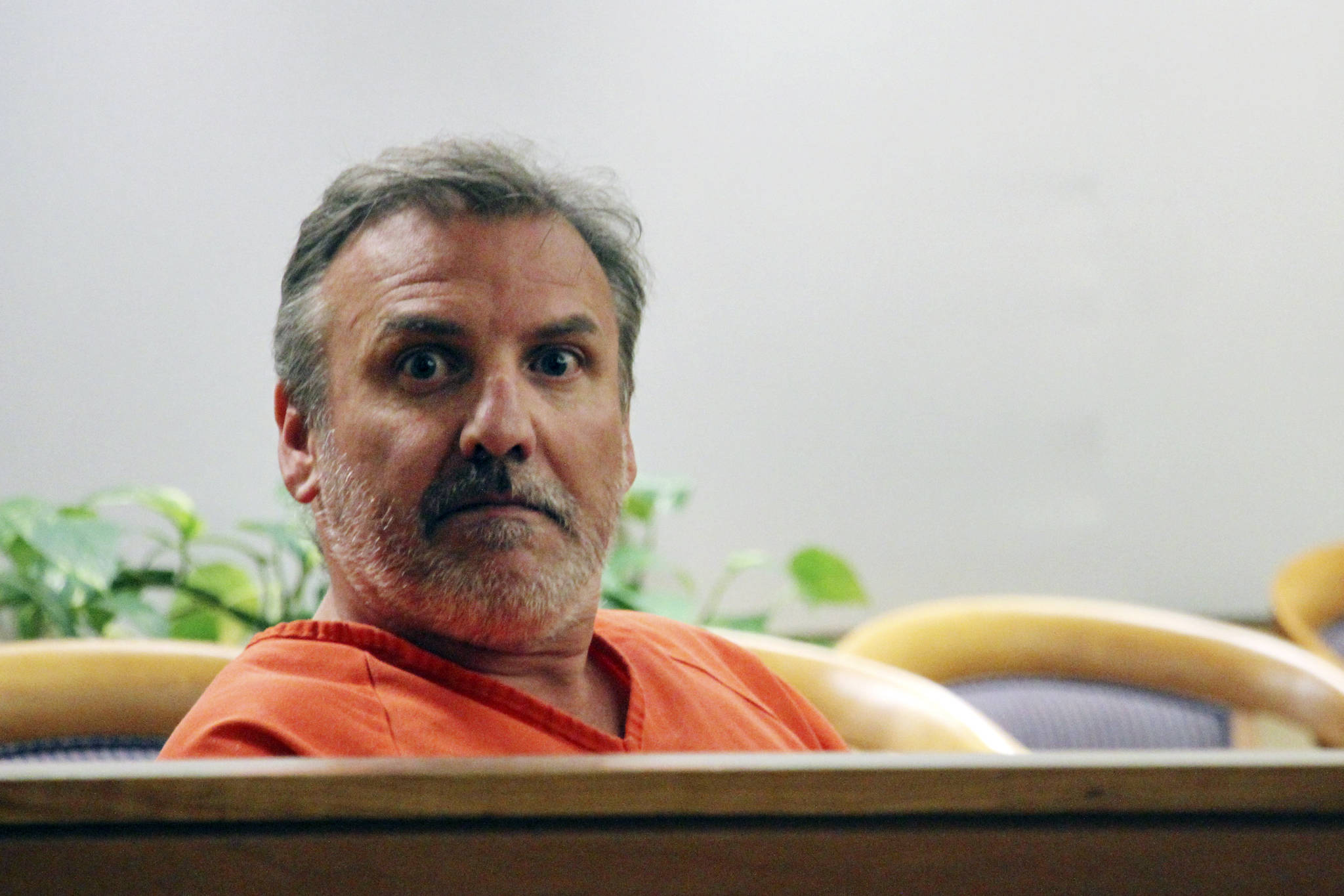 Brian Steven Smith looks out in the courtroom while waiting for his arraignment to start Wednesday, Oct. 16, 2019, in Anchorage, Alaska. A public defender entered not guilty pleas for Smith, who is accused of documenting the assault and murder of Kathleen Henry in an Anchorage hotel. (AP Photo/Mark Thiessen)