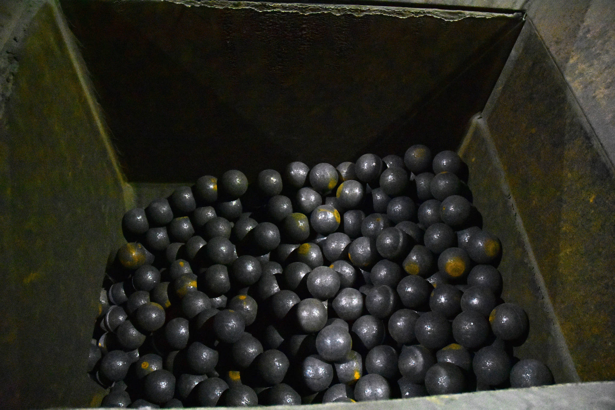 Steel mill balls waiting to be loaded into a massive tumbler where they’re used to crush rock from the mine, Monday, Oct. 14, 2019. (Peter Segall | Juneau Empire)