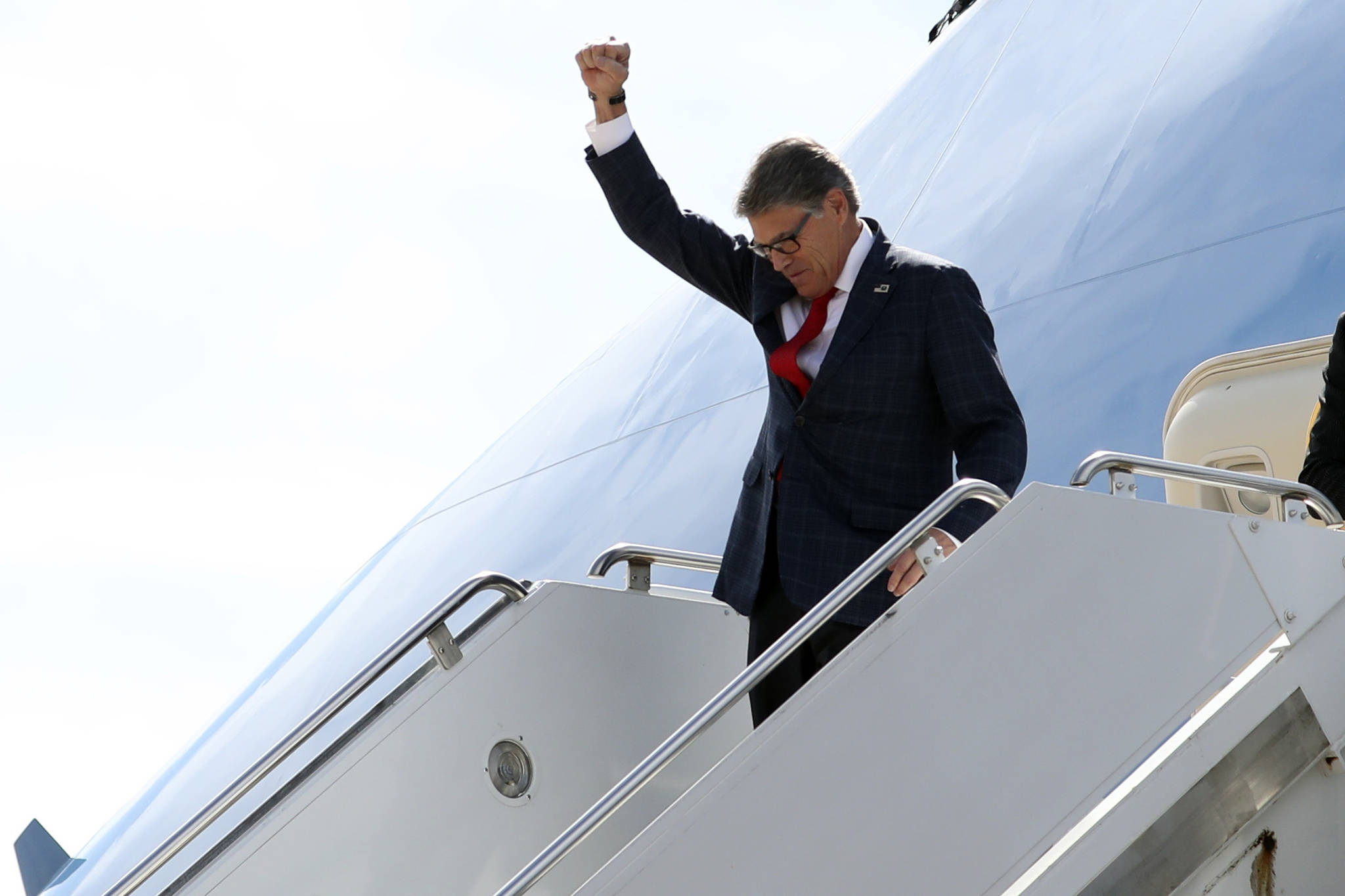 Energy Secretary Rick Perry gestures as he arrives on Air Force One with President Donald Trump at Naval Air Station Joint Reserve Base in Fort Worth, Texas, Thursday, Oct. 17, 2019. (AP Photo/Andrew Harnik)