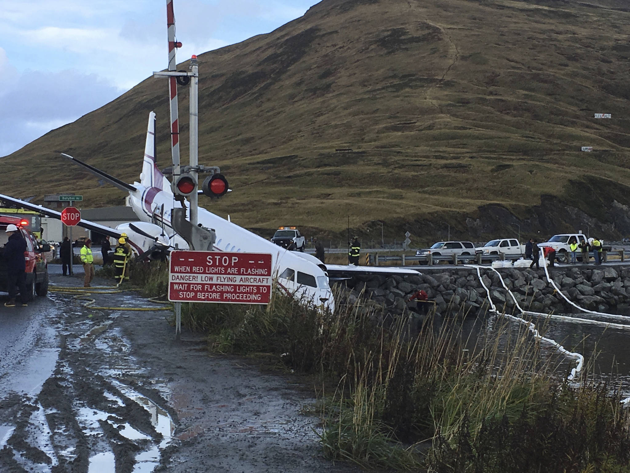 A commuter airplane has crashed near the airport in a small Alaska community on the Bering Sea, Thursday, Oct. 17, 2019, in Unalaska, Alaska. Freelance photographer Jim Paulin says the crash at the Unalaska airport occurred Thursday after 5 p.m. Paulin says the Peninsula Airways flight from Anchorage to Dutch Harbor landed about 500 feet (152 meters) beyond the airport near the water. (Jim Paulin via AP)