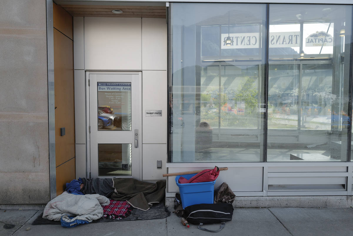 A homeless person sleeps in the doorway at the Capital Transit Center on Tuesday, Aug. 13, 2019. (Michael Penn | Juneau Empire File)