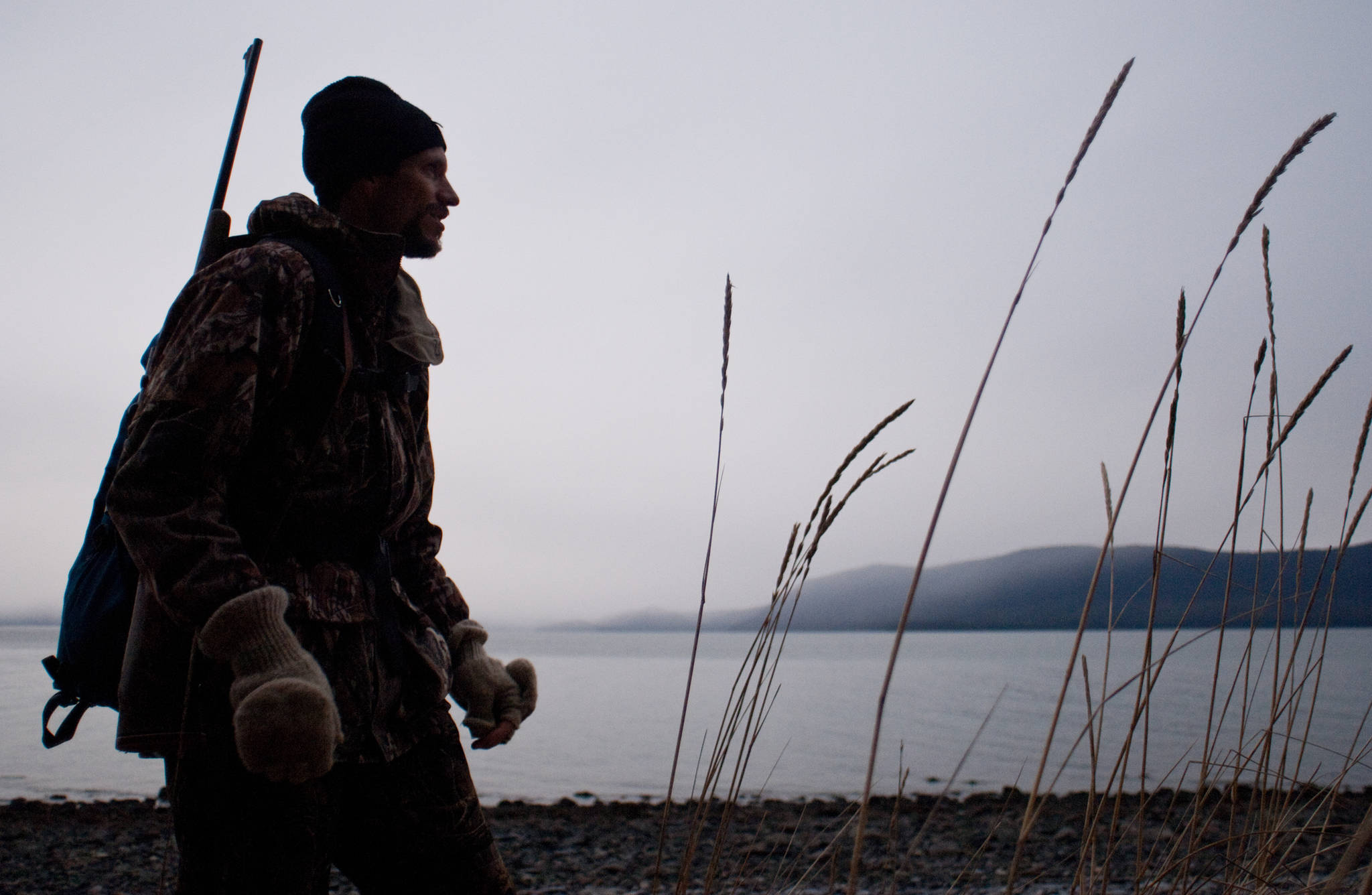 In this Empire file photo, Tom Schwartz hunts for deer along a beach on the west side of Douglas Island in December 2005. (Juneau Empire File)