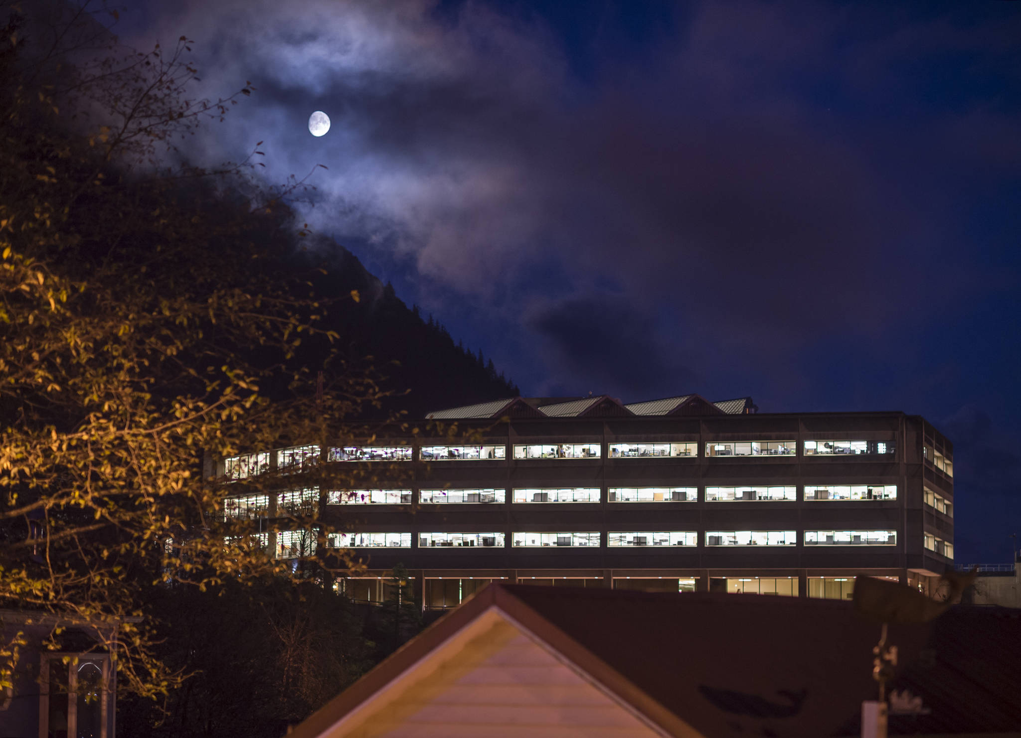 The moon rises over the State Office Building on Halloween, Tuesday, Oct. 31, 2017. (Michael Penn | Juneau Empire File)