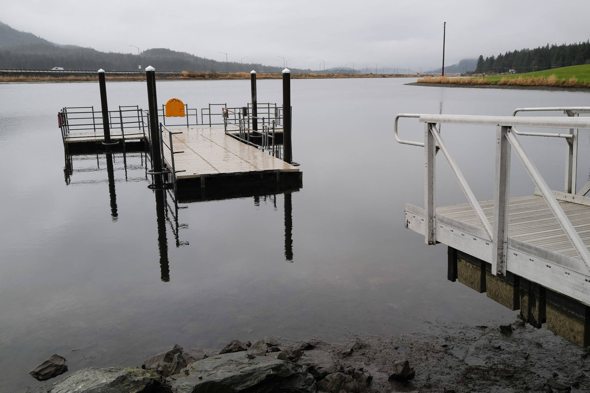 The ramp to a floating dock is shown removed from Twin Lakes on Wednesday, Oct. 30, 2019. The city is looking to knock back the plant by lowering the lake level to allow the plants to freeze, and in the spring, flood the lake with salt water. (Michael Penn | Juneau Empire)