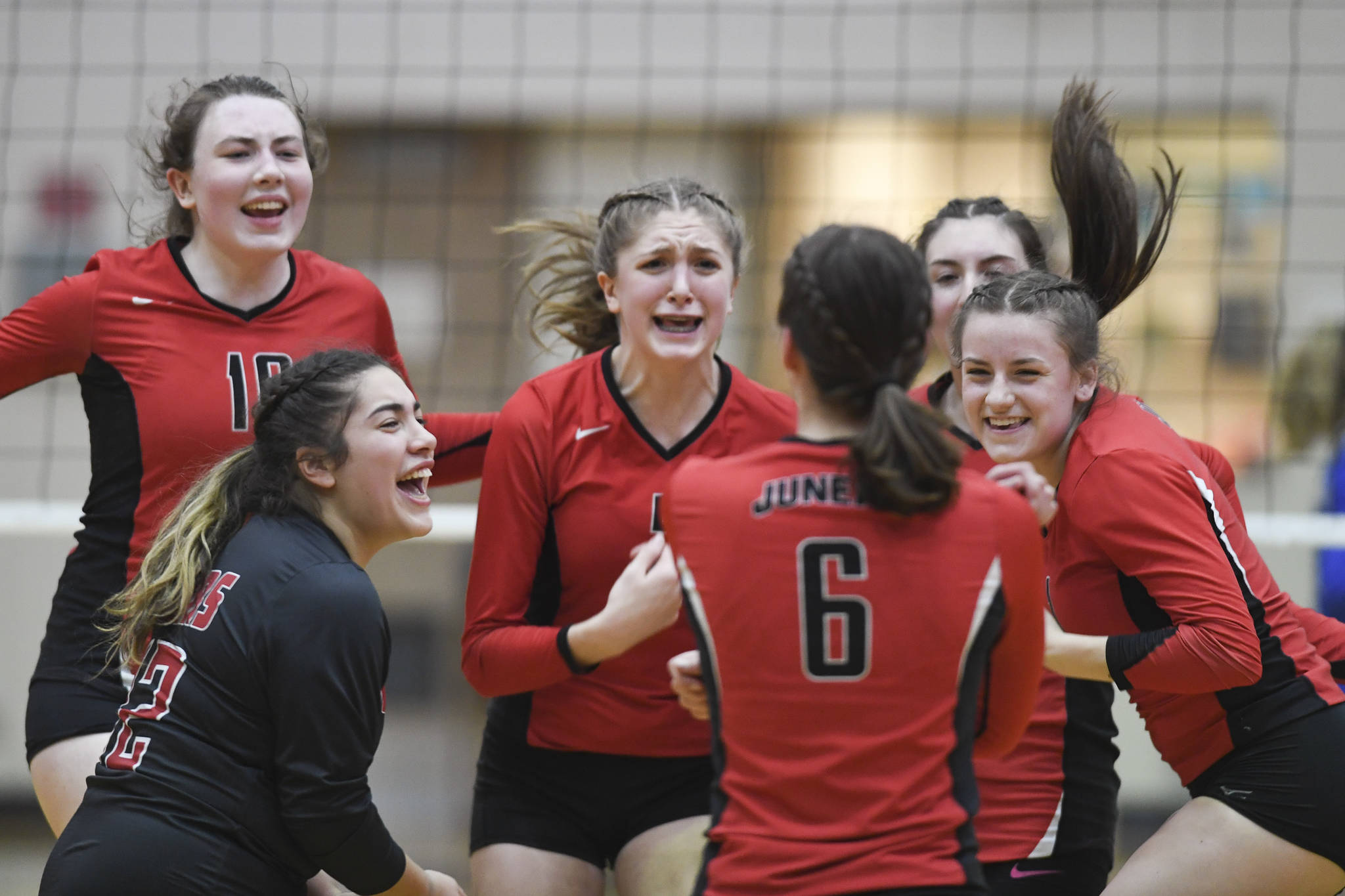 Juneau-Douglas’ Addie Prussing (6) is cheered by her teammates after a point against Thunder Mountain at Juneau-Douglas High School: Yadaa.at Kalé on Friday, Nov. 1, 2019. Thunder Mountain won 3-0 (25-14, 25-20, 25-20). (Michael Penn | Juneau Empire)