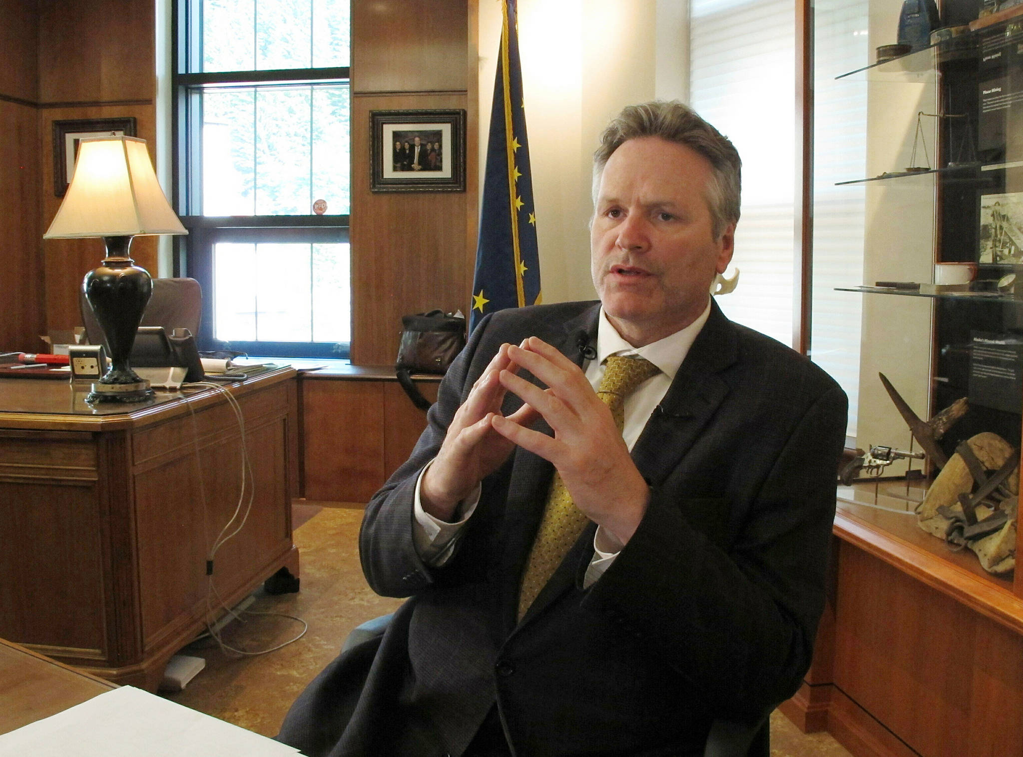 In this May 29 photo, Alaska Gov. Mike Dunleavy speaks to reporters in his office at the state Capitol in Juneau, Alaska. A fight is brewing over whether Dunleavy, a Republican who took office in Dec. 2018, should be recalled. Critics say he’s incompetent and has recklessly tried to cut spending while supporters see a politically motivated attempt to undo the last election. (AP Photo | Becky Bohrer)