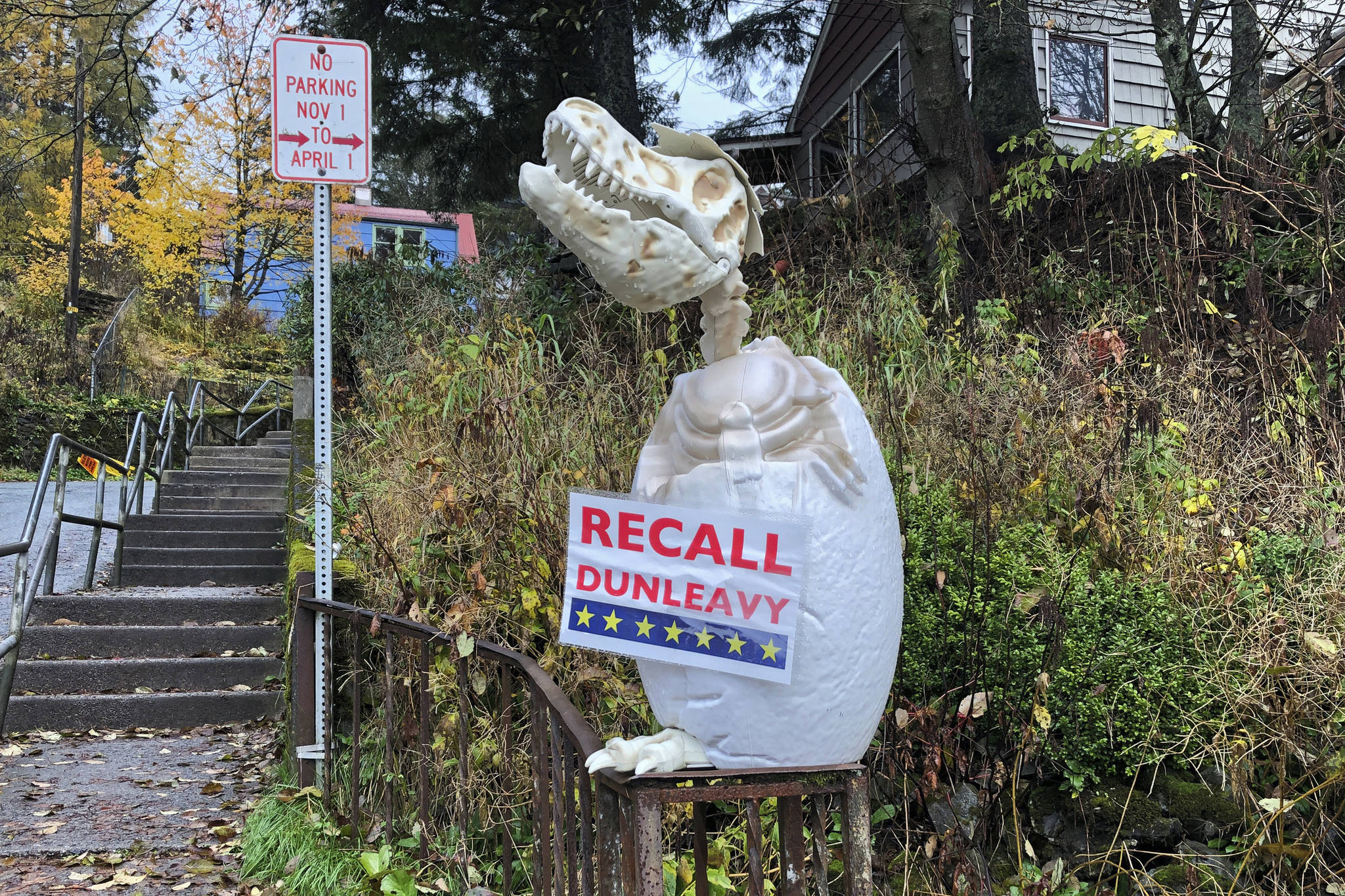 In this Friday, Nov. 1 photo, a sign reading “Recall Dunleavy” hangs from a decoration in front of a yard near the Alaska governor’s mansion in Juneau. A fight is brewing in the state over whether Republican Gov. Mike Dunleavy should be recalled from office, with his critics saying he’s incompetent and has recklessly tried to cut spending while supporters see a politically motivated attempt to undo the last election. (AP Photo | Becky Bohrer)