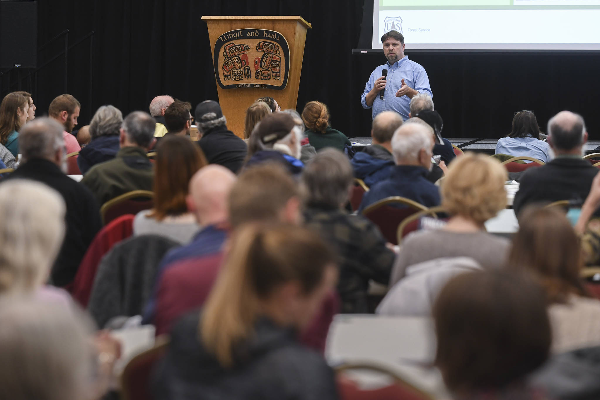 Juneau residents listen to a U.S. Department of Agriculture Forest Service informational meeting lead by National Forest System Deputy Chief Chris French on the Rulemaking for Alaska Roadless Areas Draft Environmental Impact Statement at Elizabeth Peratrovich Hall on Monday, Nov. 4, 2019. (Michael Penn | Juneau Empire)