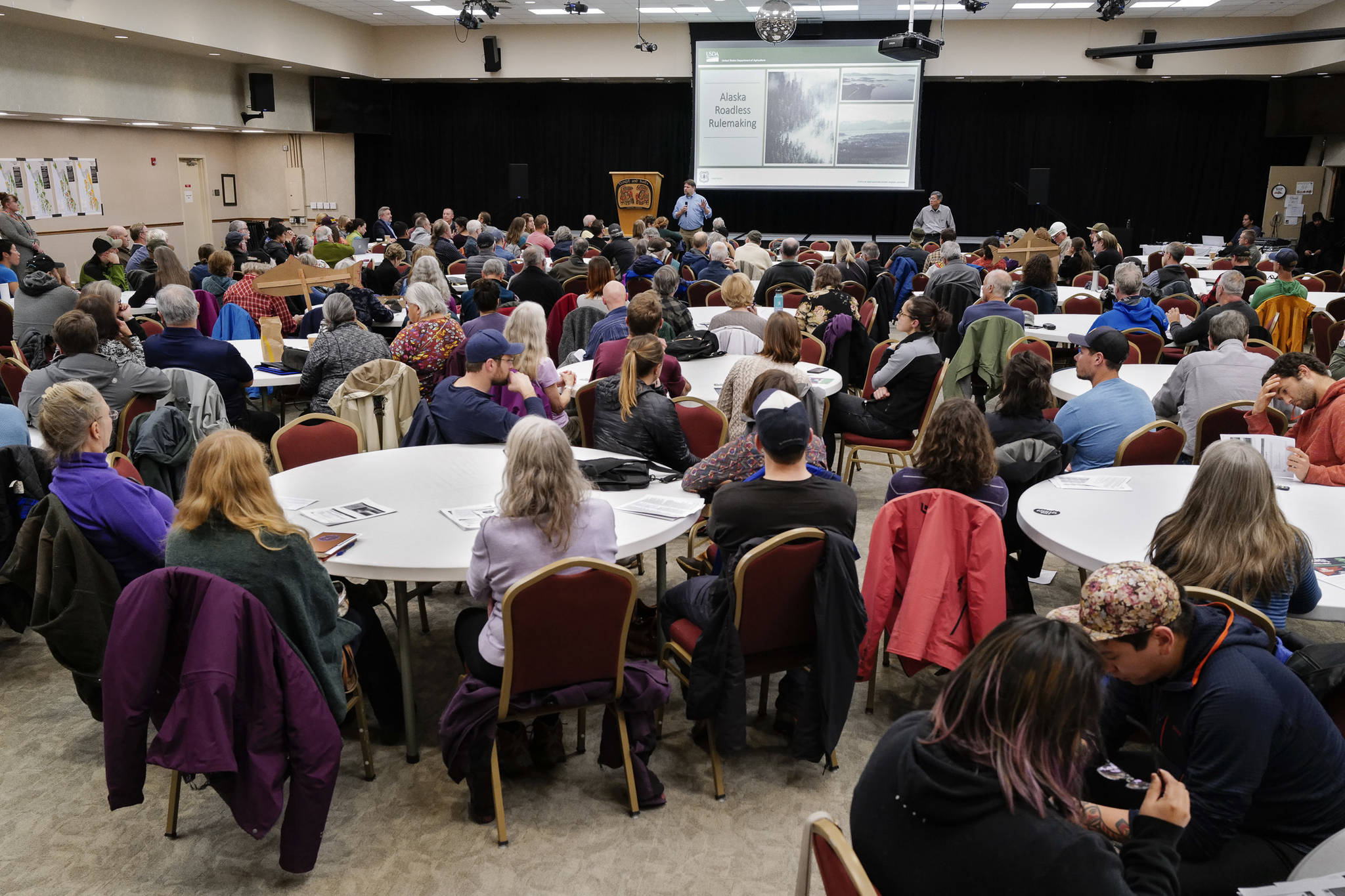 Juneau residents listen to a U.S. Department of Agriculture Forest Service informational meeting on the Rulemaking for Alaska Roadless Areas Draft Environmental Impact Statement at Elizabeth Peratrovich Hall on Monday, Nov. 4, 2019. (Michael Penn | Juneau Empire)