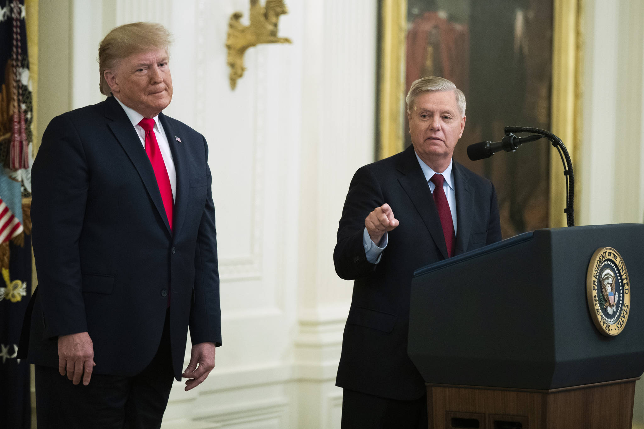 President Donald Trump listens to Sen. Lindsey Graham, R-S.C., speak during a ceremony in the East Room of the White House where Trump spoke about his judicial appointments, Wednesday, Nov. 6, 2019, in Washington. (AP Photo | Manuel Balce Ceneta)
