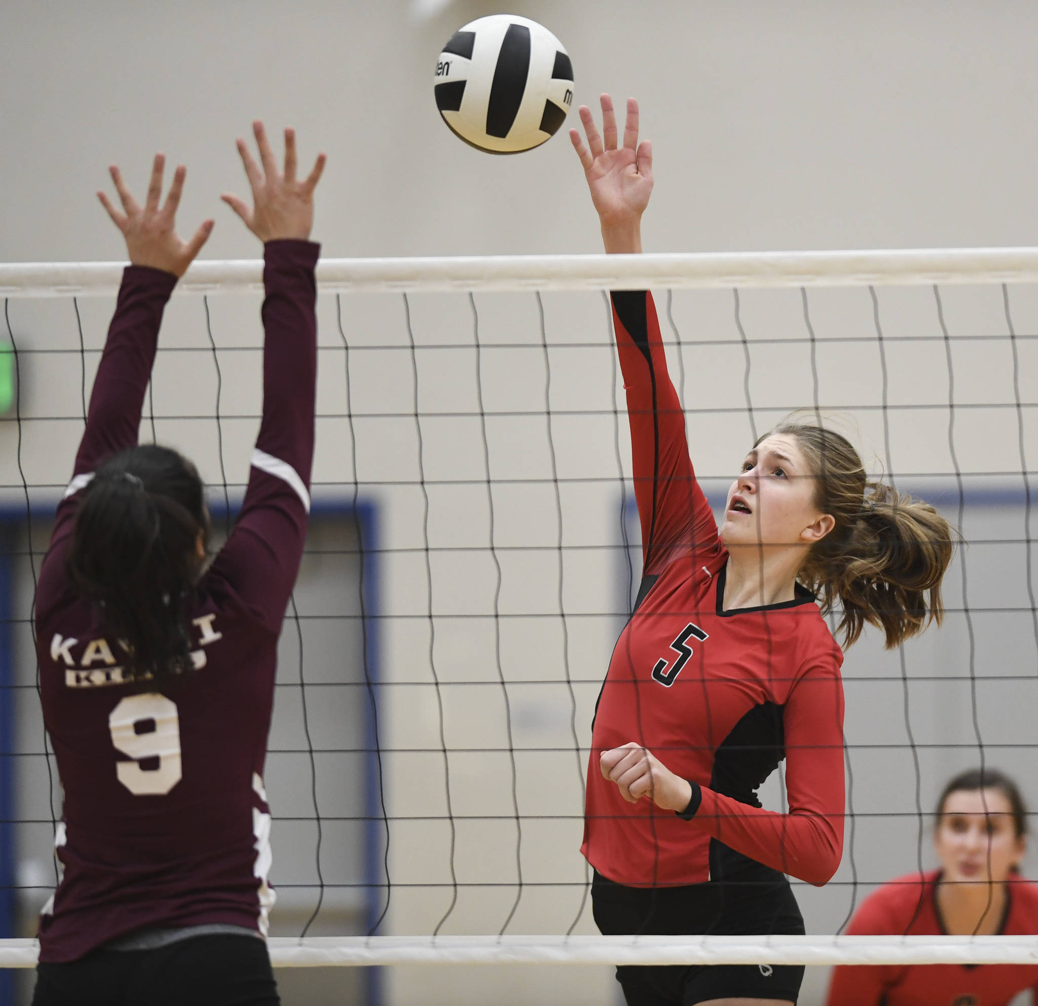 Juneau-Douglas’ Brooke Sanford, right, spikes against Ketchikan’s Maddy Purcell during the Region V Volleyball Tournament at Thunder Mountain High School on Thursday, Nov. 7, 2019. JDHS won 25-8, 25-14, 14-25, 25-15. (Michael Penn | Juneau Empire)