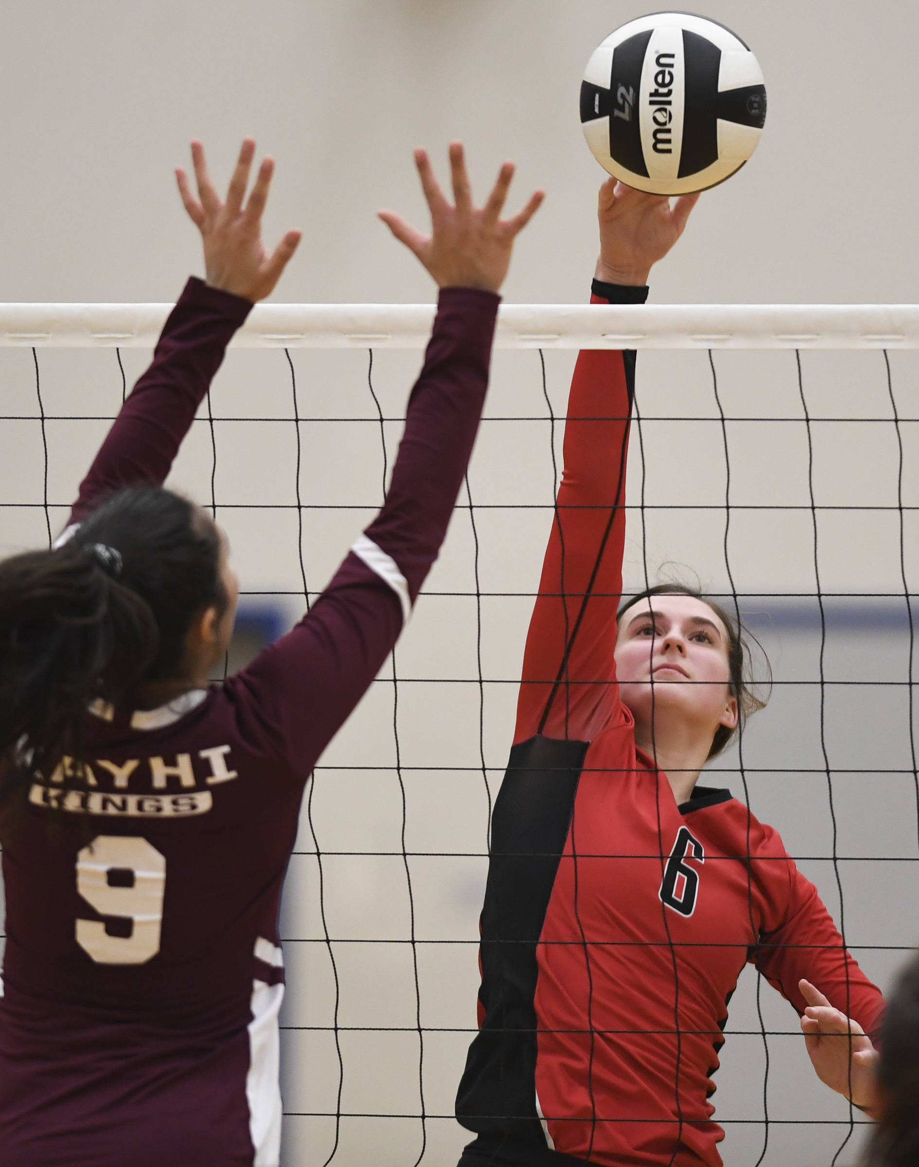 Juneau-Douglas’ Addie Prussing spikes the ball up against Ketchikan’s Maddy Purcell during the Region V Volleyball Tournament at Thunder Mountain High School on Thursday, Nov. 7, 2019. JDHS won 25-8, 25-14, 14-25, 25-15. (Michael Penn | Juneau Empire)