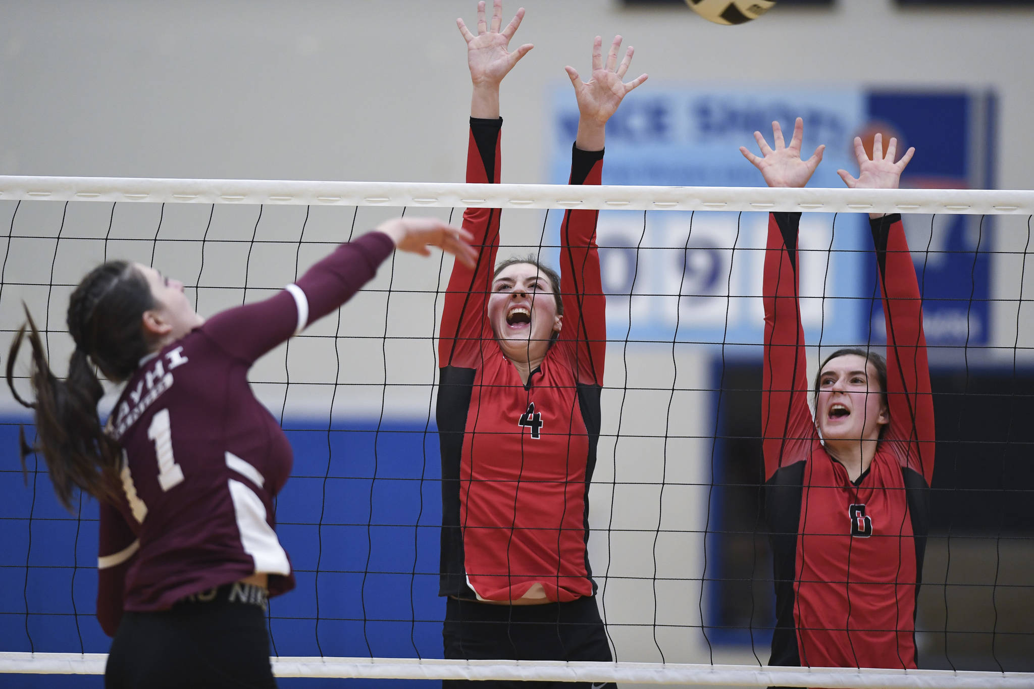 Juneau-Douglas’ Jenae Pusich, center, and Addie prussing attempt to block as shot by Ketchikan’s LIndsey Byron during the Region V Volleyball Tournament at Thunder Mountain High School on Thursday, Nov. 7, 2019. JDHS won 25-8, 25-14, 14-25, 25-15. (Michael Penn | Juneau Empire)