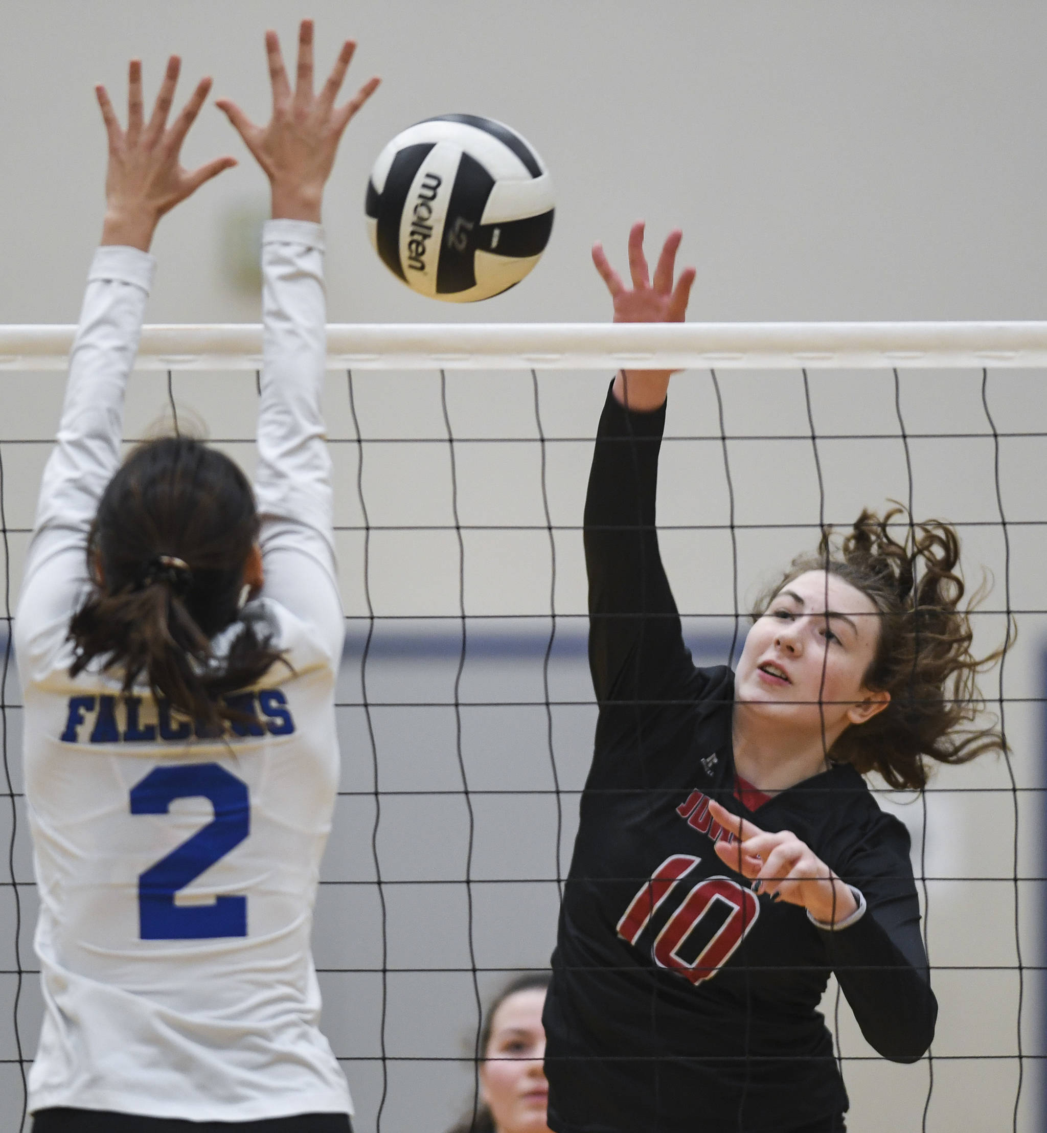Juneau-Douglas’ Merry Newman spikes the ball against Thunder Mountain’s Amy Schoonover during the Region V Volleyball Tournament at Thunder Mountain High School on Friday, Nov. 8, 2019. JDHS won 25-22, 26-24, 25-20. (Michael Penn | Juneau Empire)