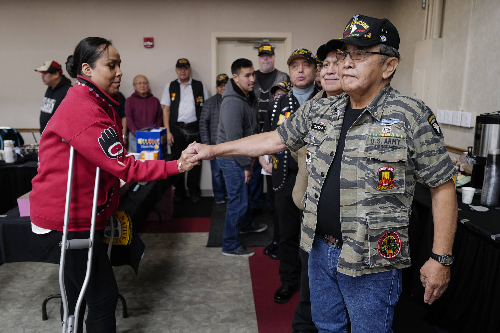 U.S. Army Veteran Tamera Paul, left, greets U.S. Army Veteran James Lindoff during the Southeast Alaska Native Veteran’s Veterans Day luncheon at the Elizabeth Peratrovich Hall on Monday, Nov. 11, 2019. (Michael Penn | Juneau Empire)
