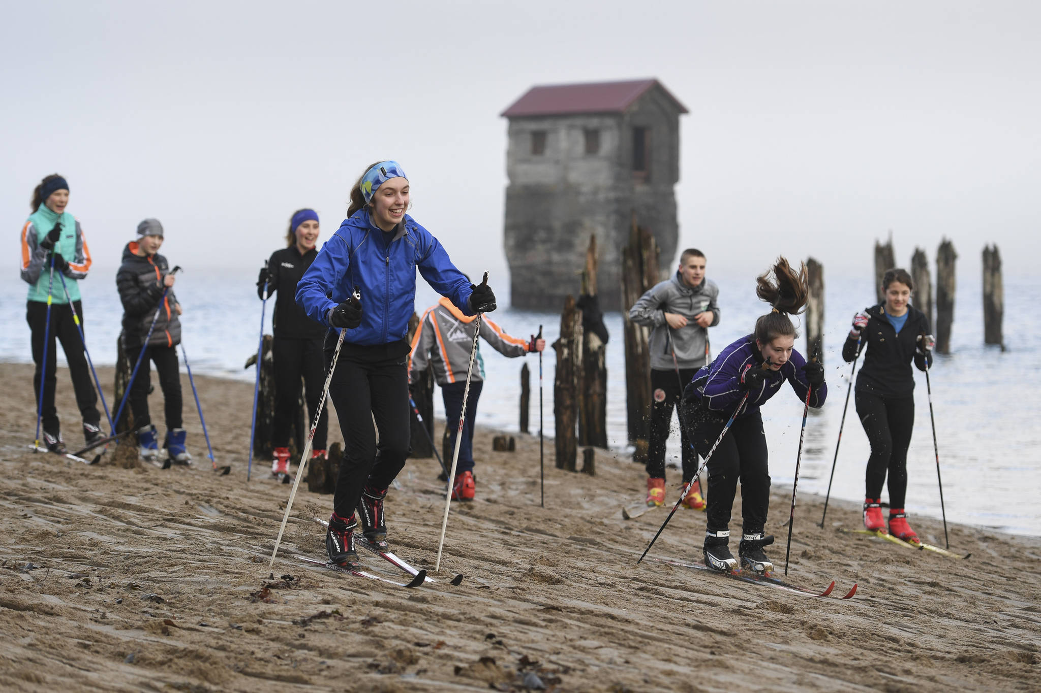 Anna Iverson, left, and Eva Goerin of the Juneau Nordic Ski Team race during practice at Sandy Beach on Friday, Nov. 8, 2019. The team, made up of middle and high school students, is finding alternative ways of training without snow as they prepare for their upcoming season. (Michael Penn | Juneau Empire)