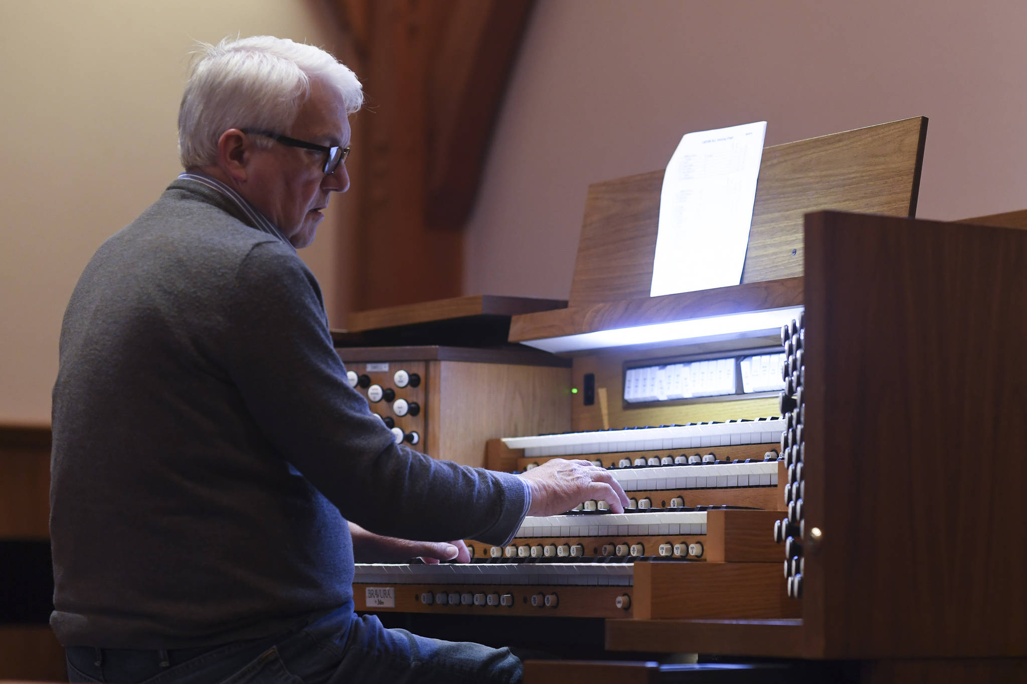 Jonas Nordwall, organist and artistic director of music for the First United Methodist Church in Portland, Oregon, works on Thursday at preparing a 2013 Allen Bravura Organ for its first public concert at Holy Trinity Episcopal Church. Learn more by watching the video below. (Michael Penn | Juneau Empire)