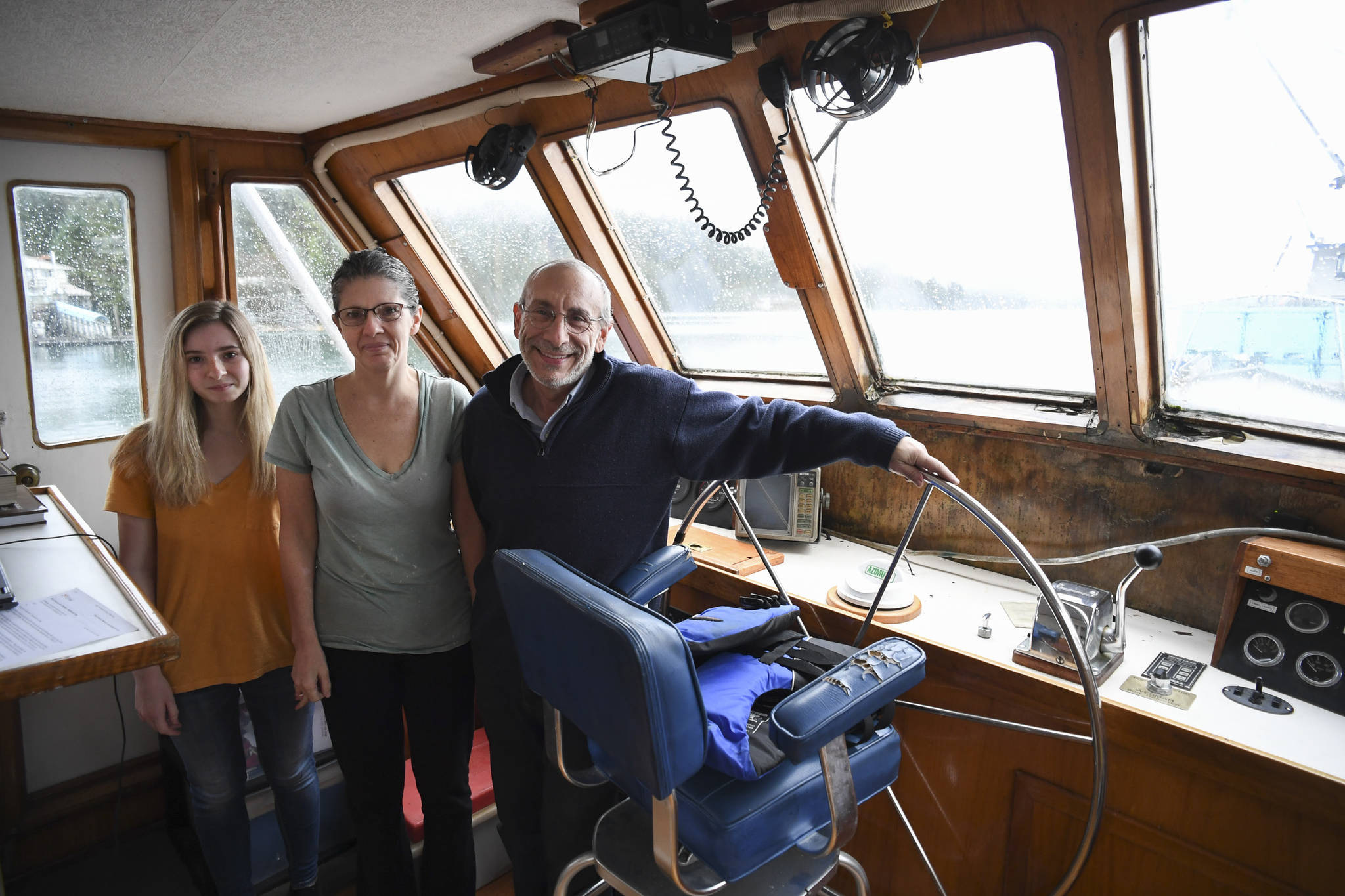 Rabbi Yehoshua Mizrachi, his partner Sheila McNamee and her daughter, Helena, 19, aboard their newly bought custom built 52-foot trawler, the M/V Sephina, in the Don D. Statter Memorial Boat Harbor in Auke Bay on Wednesday, Nov. 13, 2019. Rabbi Mizrachi said he found the boat of his dreams and traveled across the country to pick it up in Hoonah this summer. (Michael Penn | Juneau Empire)