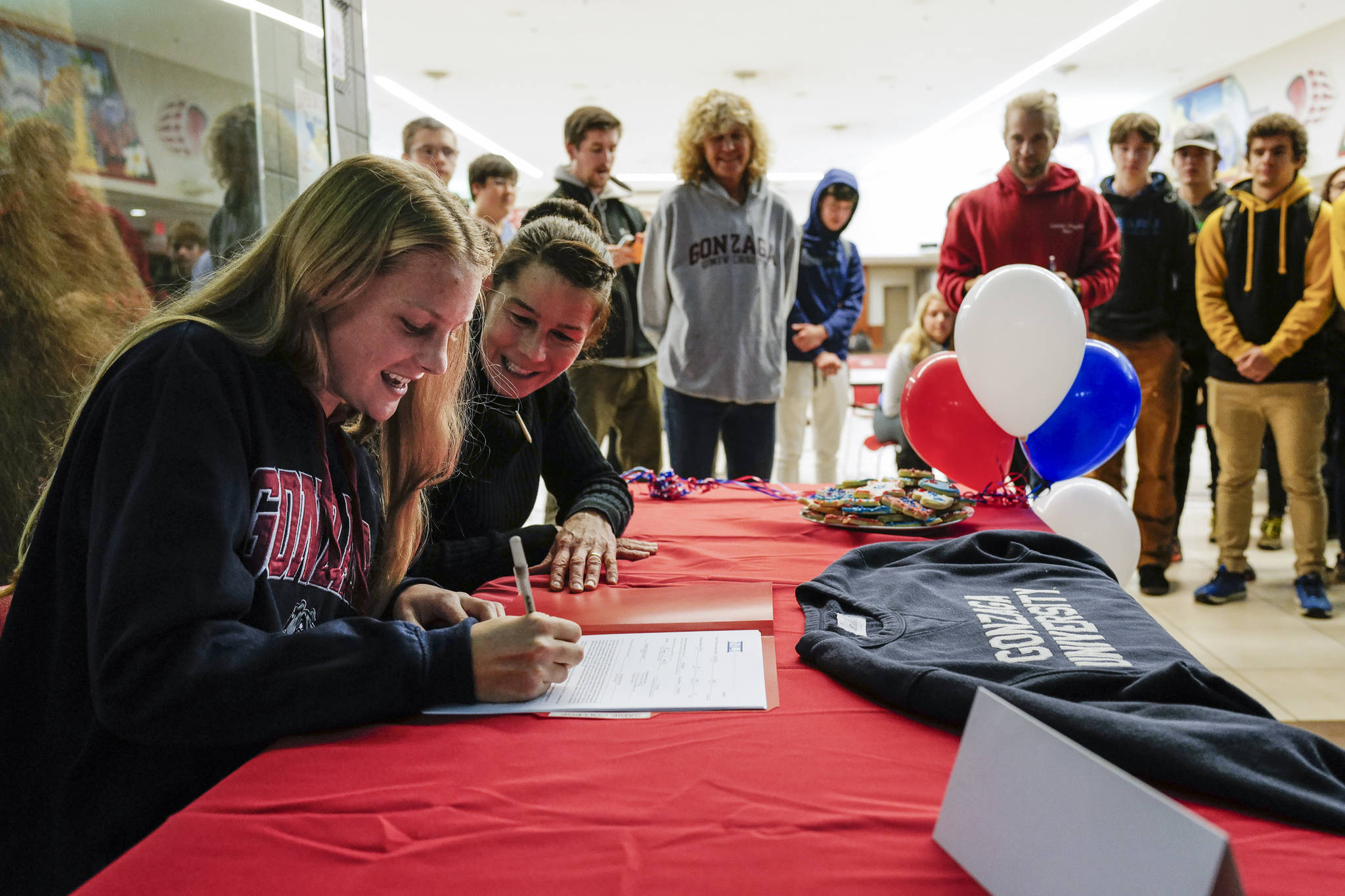Juneau-Douglas High School: Yadaa.at Kalé senior Sadie Tuckwood signs a National Letter of Intent with Gonzaga University with her mother, Cindy, watching on Monday, Nov. 18, 2019. (Michael Penn | Juneau Empire)
