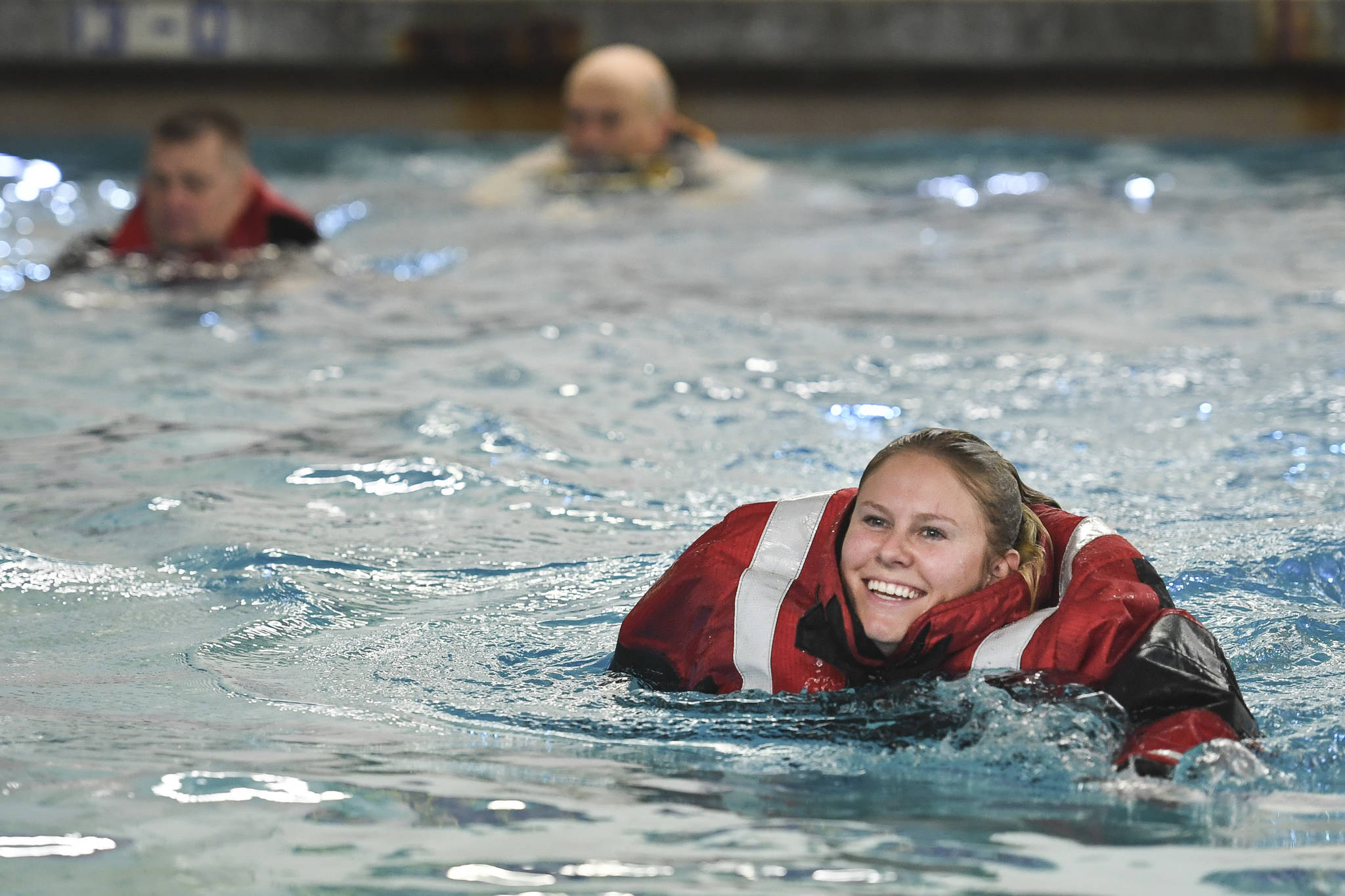 Operational Specialist 1st Class Marylee Florscher, a Coast Guardsman stationed in Juneau, takes a boating safety training class at the Augustus Brown Swimming Pool on Tuesday, Nov. 19, 2019. The class will qualify the members to teach students around the state about the use and importance of life vests. (Michael Penn | Juneau Empire)