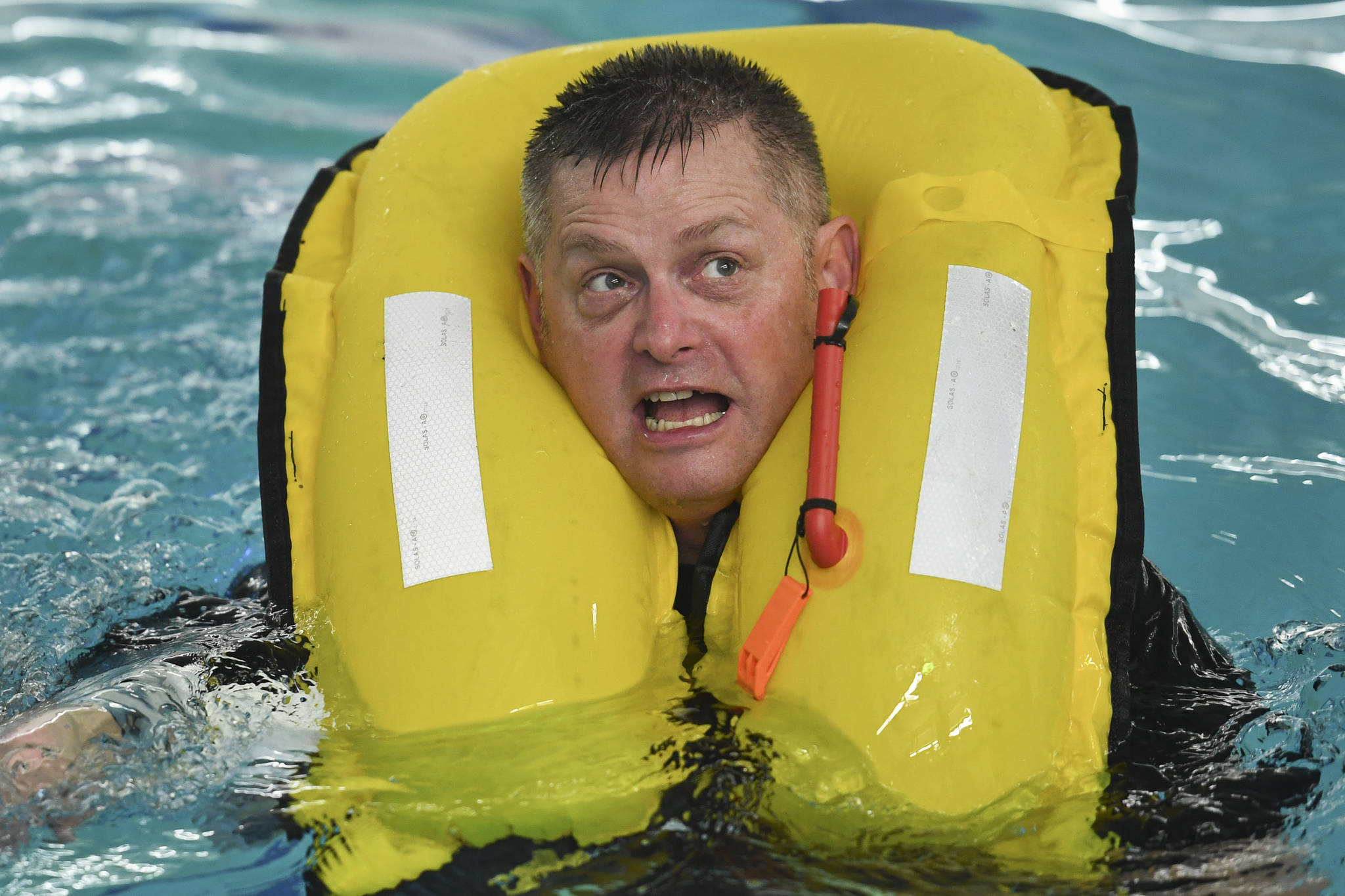 Lt. Cmdr. Kevin Dugan, a Coast Guards officer stationed in Juneau, takes a boating safety training class at the Augustus Brown Swimming Pool on Tuesday, Nov. 19, 2019. The class will qualify the members to teach students around the state about the use and importance of life vests. (Michael Penn | Juneau Empire)