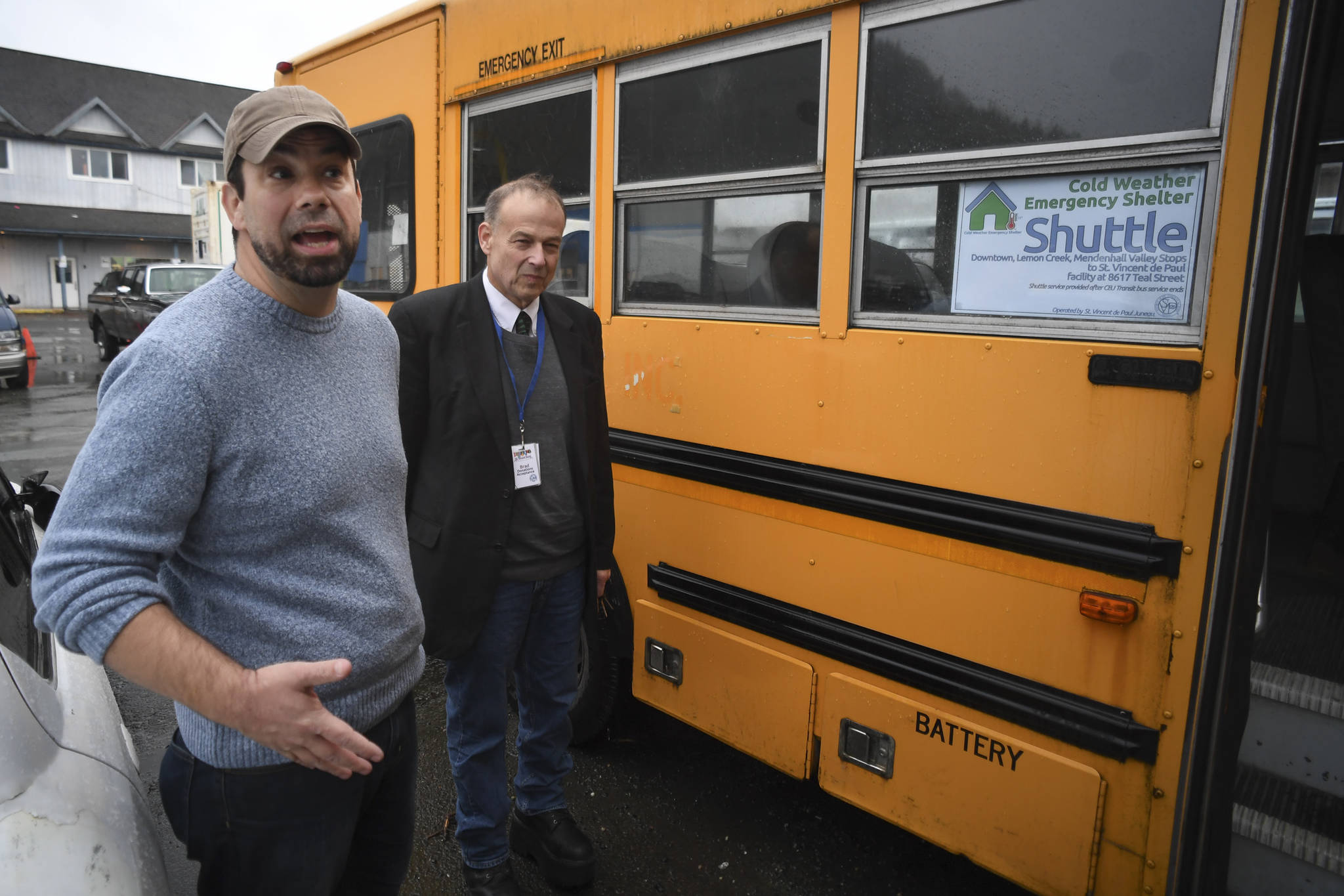 Cold Weather Emergency Shelter Manager Richard Cole, left, and St. Vincent de Paul Society Juneau General Manager Bradley Perkins show their used school bus on Wednesday, Nov. 20, 2019, that will be used to transport people needing a warm place to sleep to the shelter at St. Vincent de Paul. (Michael Penn | Juneau Empire)