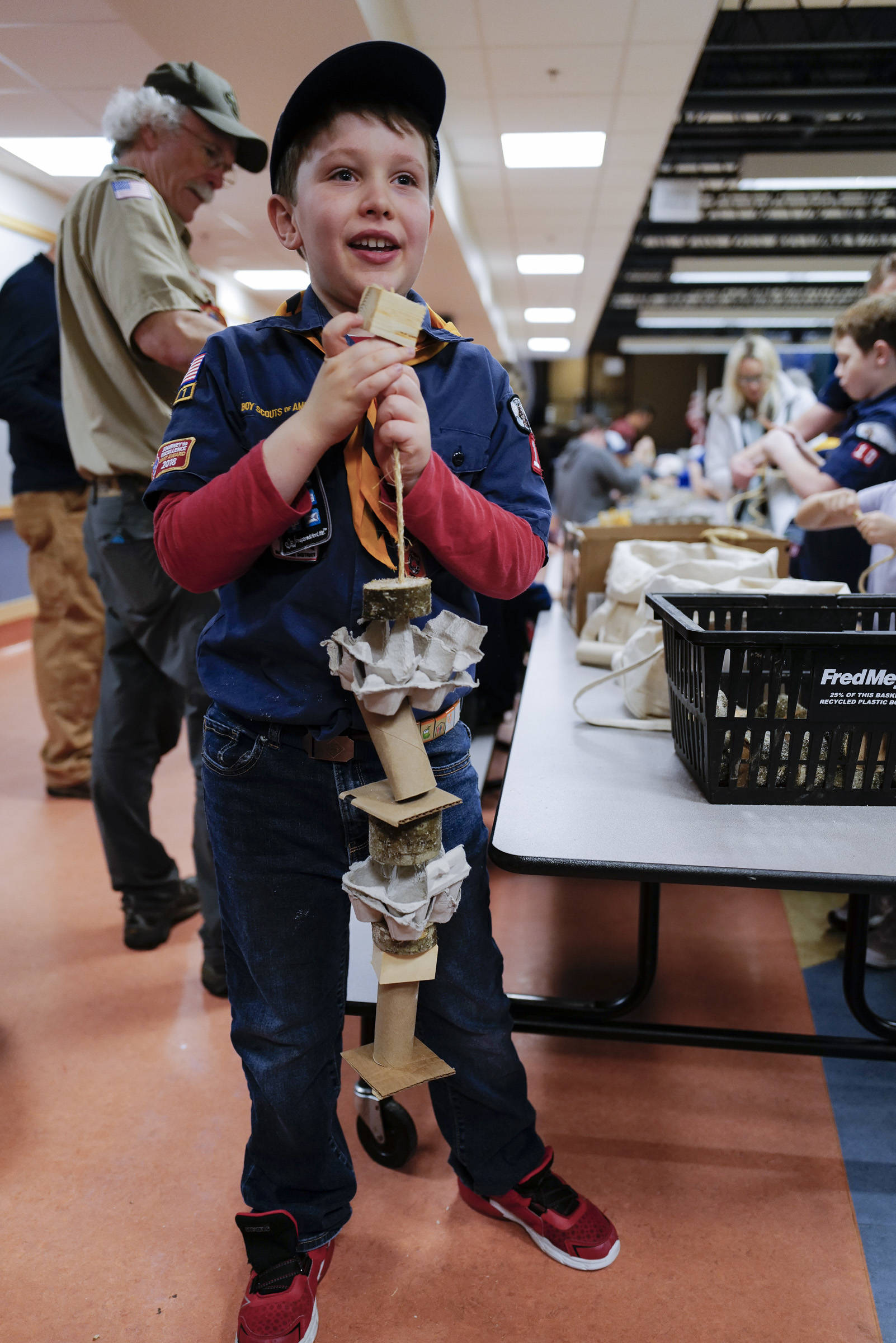 Oliver Robertson, 8, tops off an enrichment toy for birds he constructed during a cub scout pack meeting at Harborview Elementary School on Friday, Nov. 22, 2019. About 25 cub scouts constructed the toys as a service project for the Juneau Raptor Center. (Michael Penn | Juneau Empire)