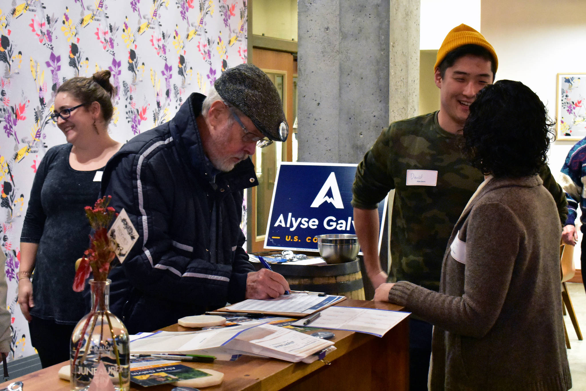 Supporters of Alyse Galvin, an Independent challenger to Rep. Don Young, R-Alaska, sign up for a mailing list at a campaign fundraiser at Amalga Distillery on Saturday, Nov. 23, 2019. (Peter Segall | Juneau Empire)