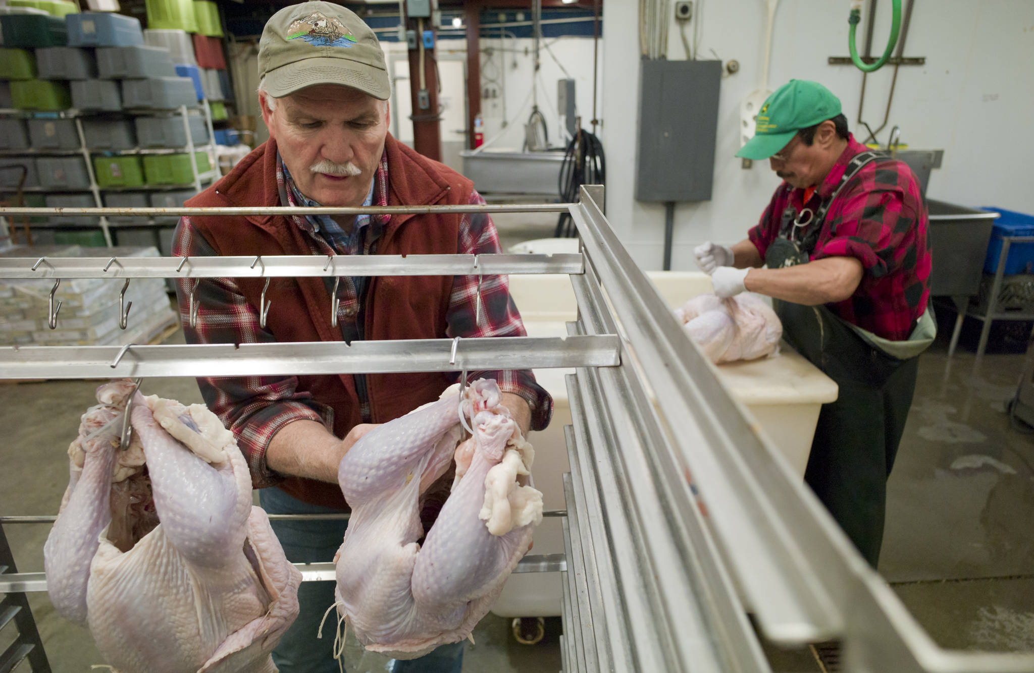 Alaskla Seafood Company owner Richard Hand, left, and Jeff Isturis prepare turkeys in November 2016 for the annual Salvational Army Thanksgiving dinner at Hangar on the Wharf. (Michael Penn | Juneau Empire File)