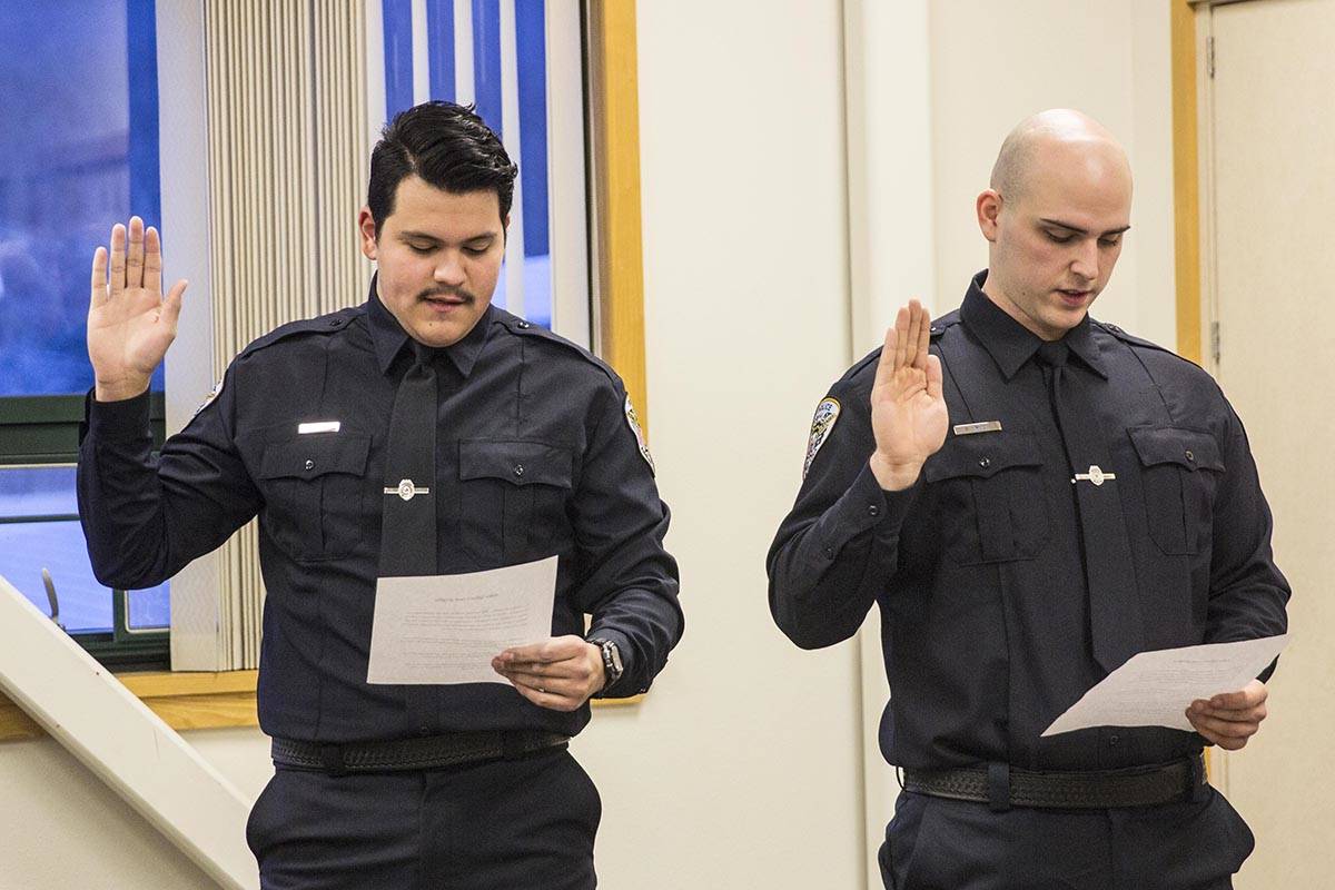 Tyler Reid, left, and Sean Imhof, right, are sworn into the Juneau Police Department as officers on Wednesday, Nov. 27, 2019. (Michael S. Lockett | Juneau Empire)