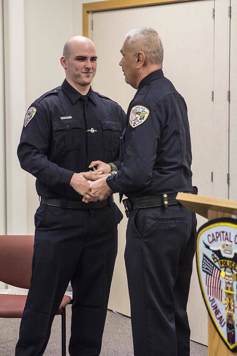 Sean Imhof shakes Chief Ed Mercer’s hand after being sworn into the Juneau Police Department as an officer on Wednesday, Nov. 27, 2019. (Michael S. Lockett | Juneau Empire)