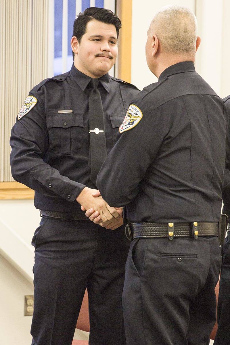 Tyler Reid shakes Chief Ed Mercer’s hand after being sworn into the Juneau Police Department as an officer on Wednesday, Nov. 27, 2019. (Michael S. Lockett | Juneau Empire)
