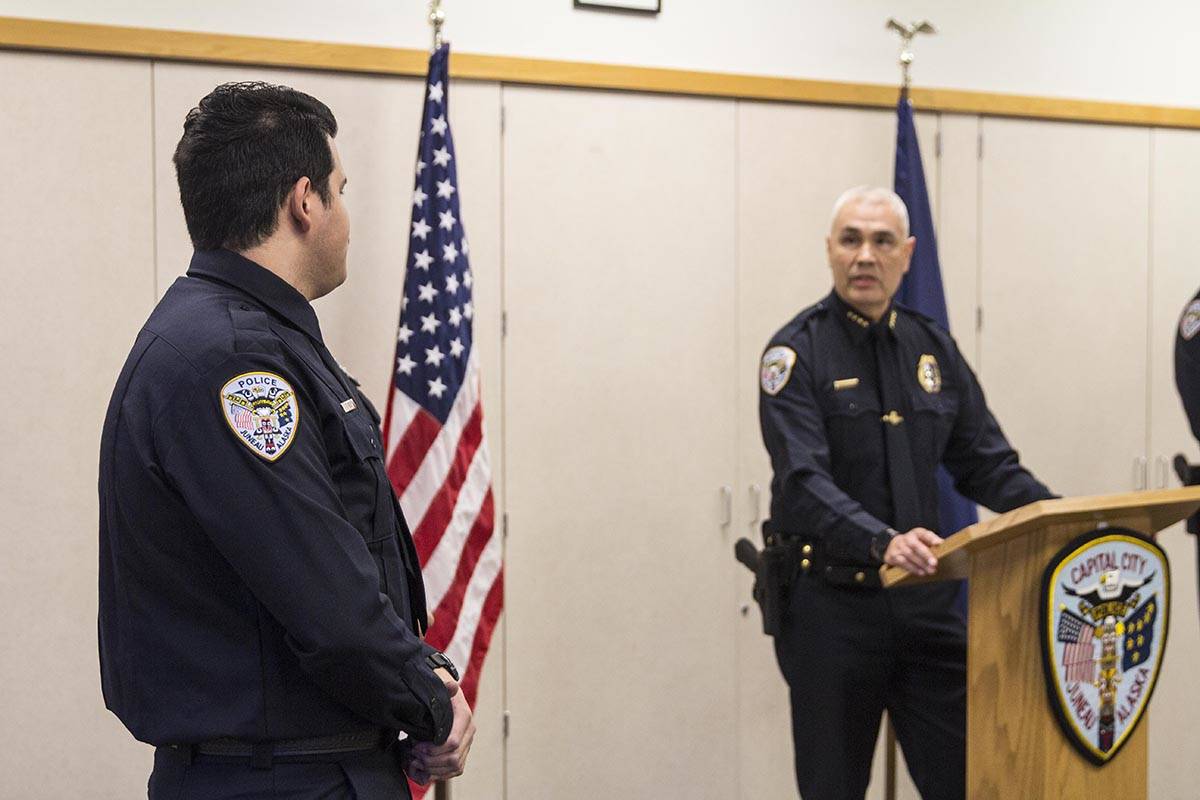 Chief Ed Mercer of the Juneau Police Department looks at Tyler Reid after swearing him in on Wednesday, Nov. 27, 2019. (Michael S. Lockett | Juneau Empire)