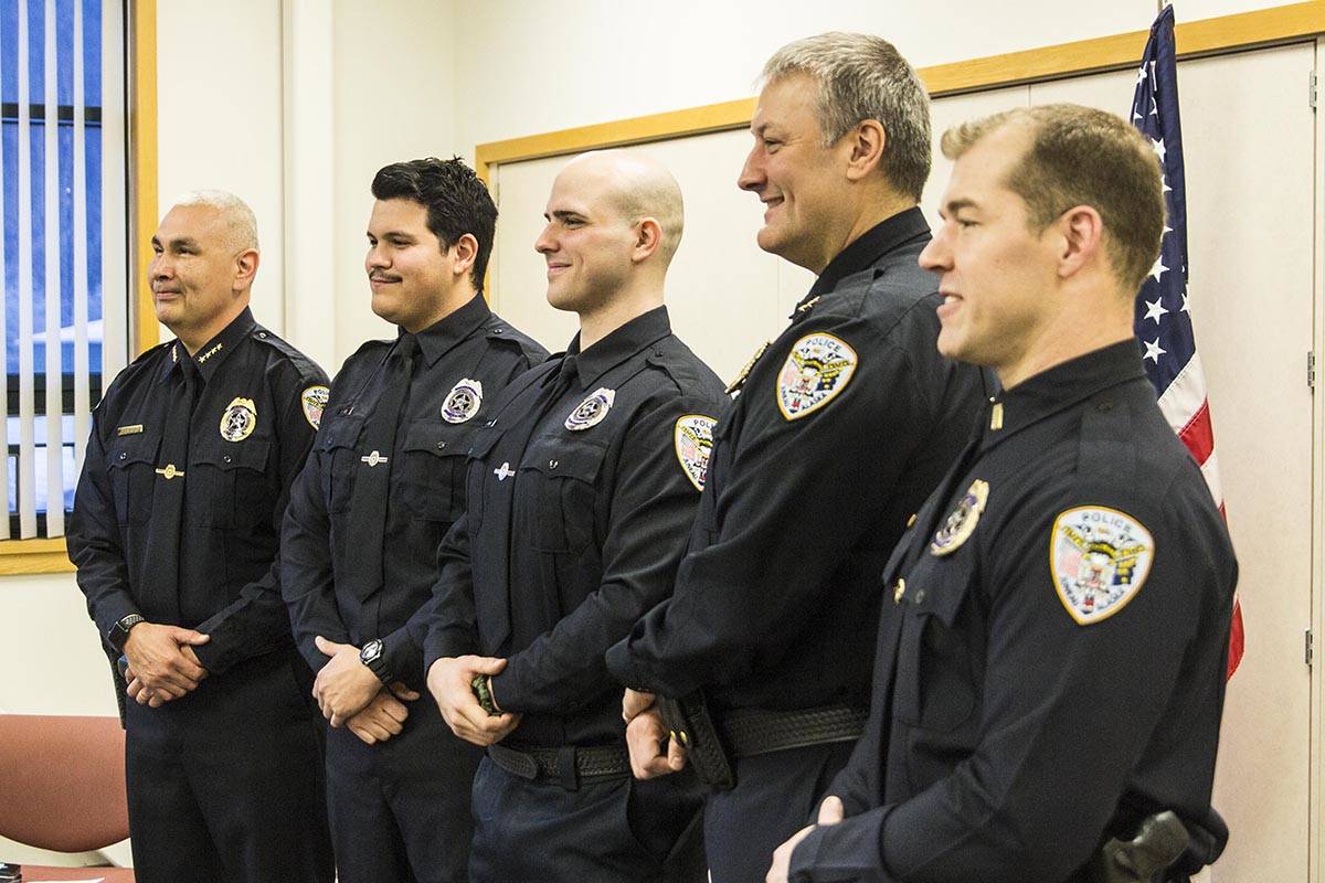 Officers of the Juneau Police Department pose for a photo with new officers after they were sworn in on Wednesday, Nov. 27, 2019. (Michael S. Lockett | Juneau Empire)