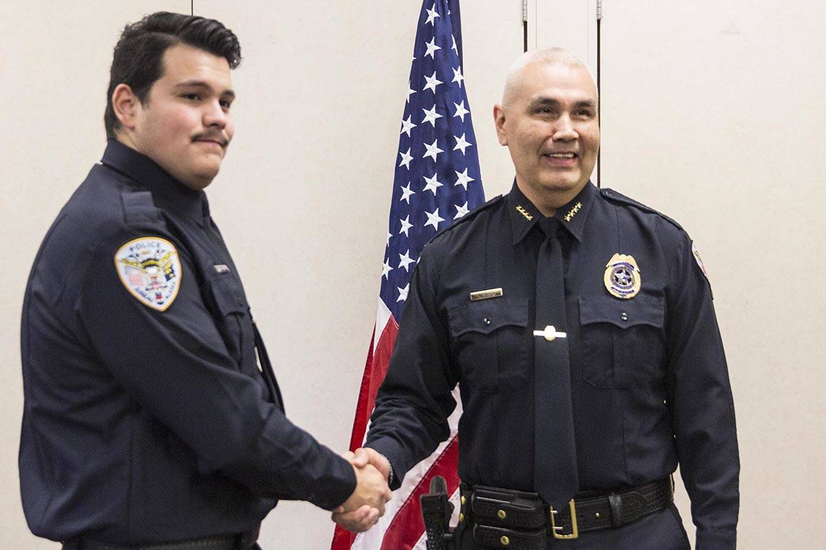Tyler Reid shakes Chief Ed Mercer’s hand after being sworn into the Juneau Police Department as an officer on Wednesday, Nov. 27, 2019. (Michael S. Lockett | Juneau Empire)