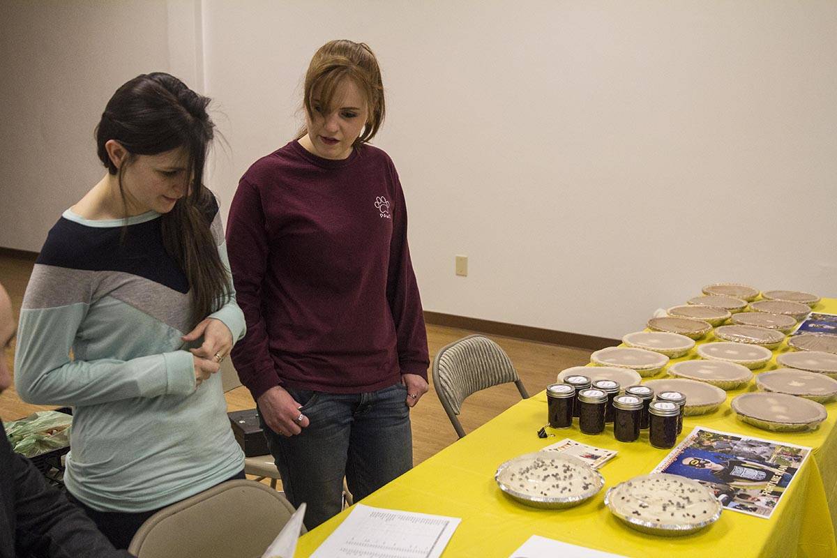 Candy Sims and Niki Bettridge review the list of pies sold as part of a fundraiser for Ryan Leonard, a seven-year-old boy with leukemia, Nov. 27, 2019. (Michael S. Lockett | Juneau Empire)
