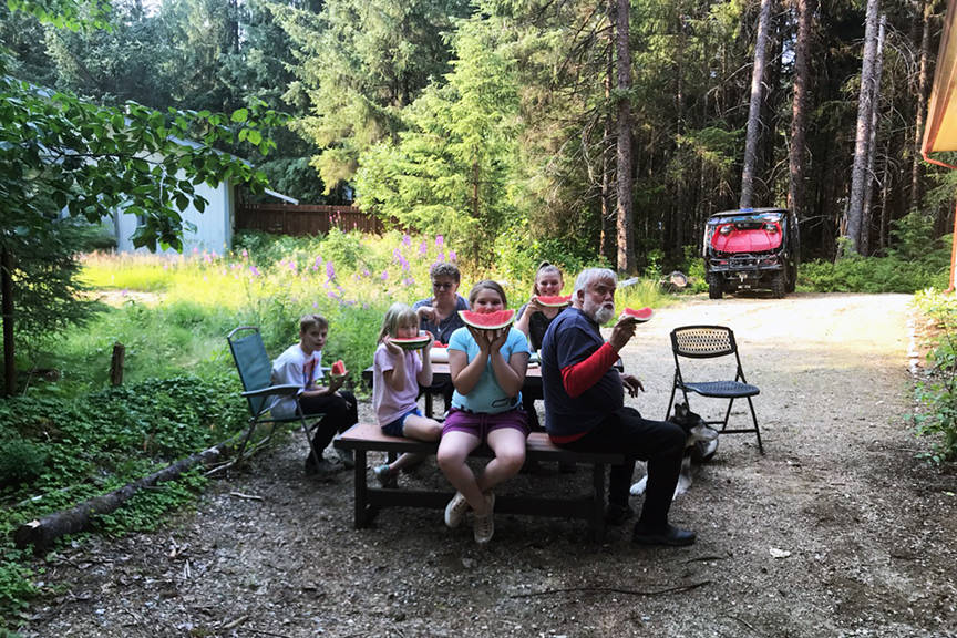 Jerry Harmon, right, and his family enjoying some watermelon. (Courtesy Photo | Juneau Salvation Army)