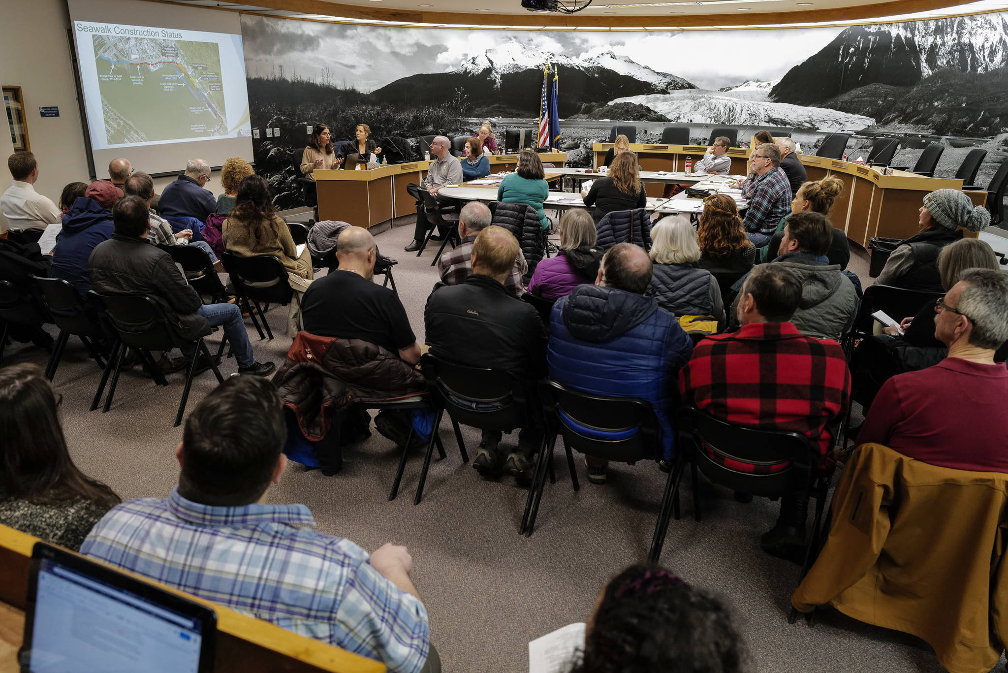 A full house watches the Tourism Industry Task Force in the Assembly chambers on Tuesday, Dec. 3, 2019. (Michael Penn | Juneau Empire)