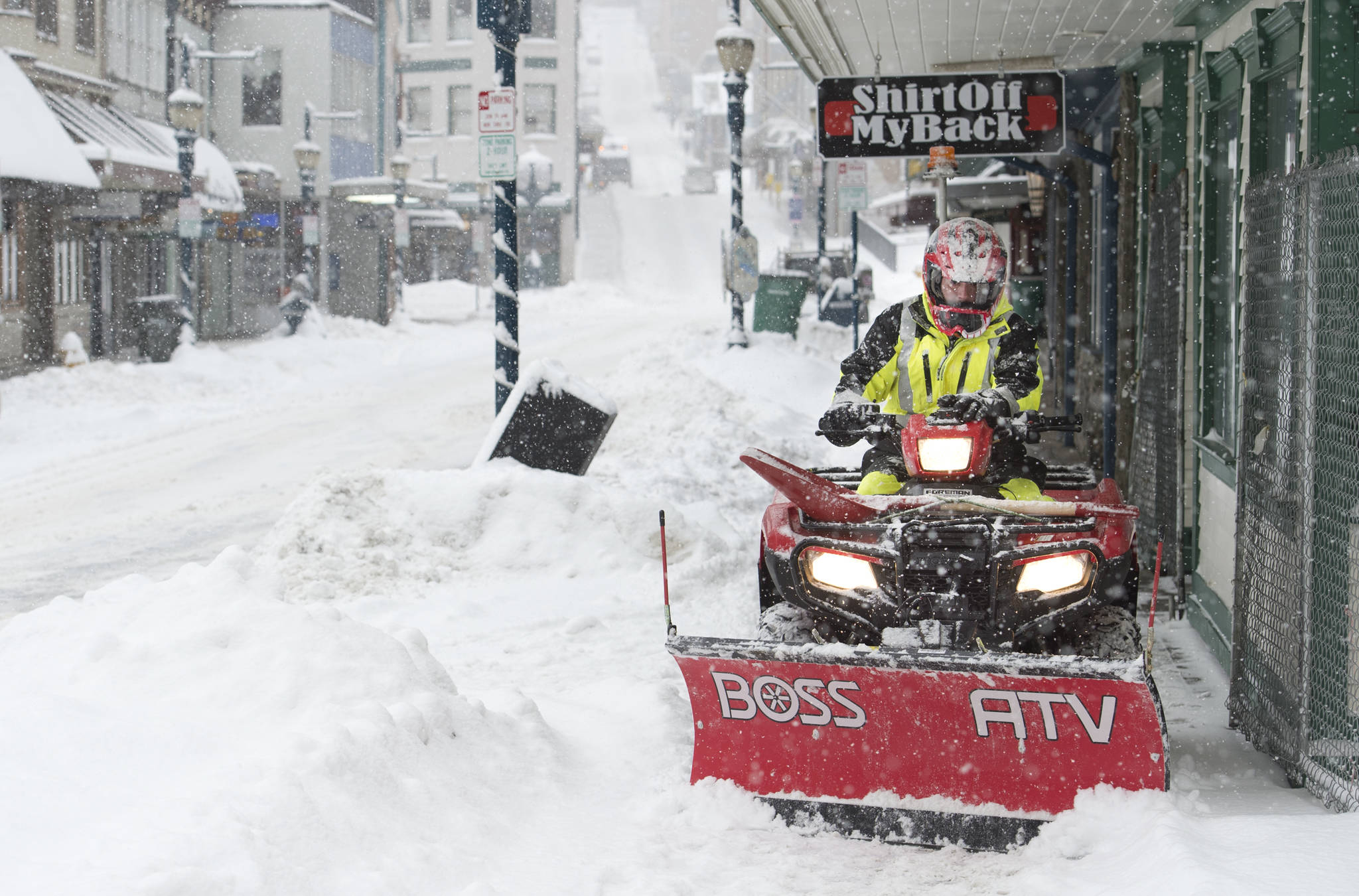 A city employee uses an all-terrain vehicle to plow Franklin Street sidewalks in this March 2017 photo. Sunday, there will be a Kid’s Day hosted by the Downtown Business Association downtown. (Michael Penn | Juneau Empire File)