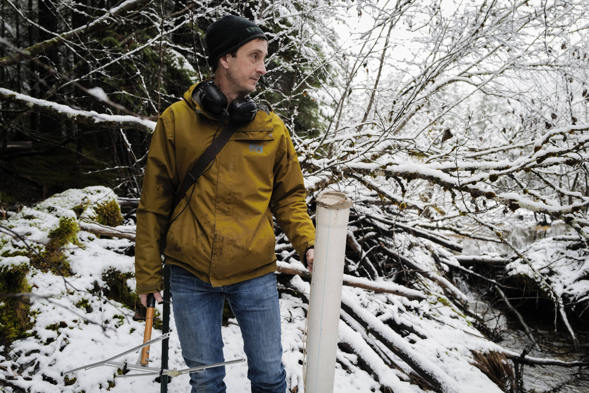 Jake Musslewhite, a fisheries biologist with the U.S. Forest Service, pauses while searching for a radio fish tag in Dredge Lake on Wednesday, Dec. 4, 2019. Musslewhite has been conducting a study tracking adult coho salmon in the Dredge Lakes drainage system. (Michael Penn | Juneau Empire)