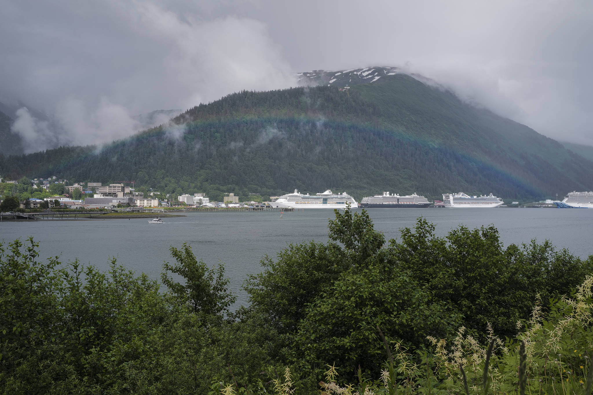 A rainbow appears over downtown Juneau on Tuesday, June 18, 2019. (Michael Penn | Juneau Empire File)