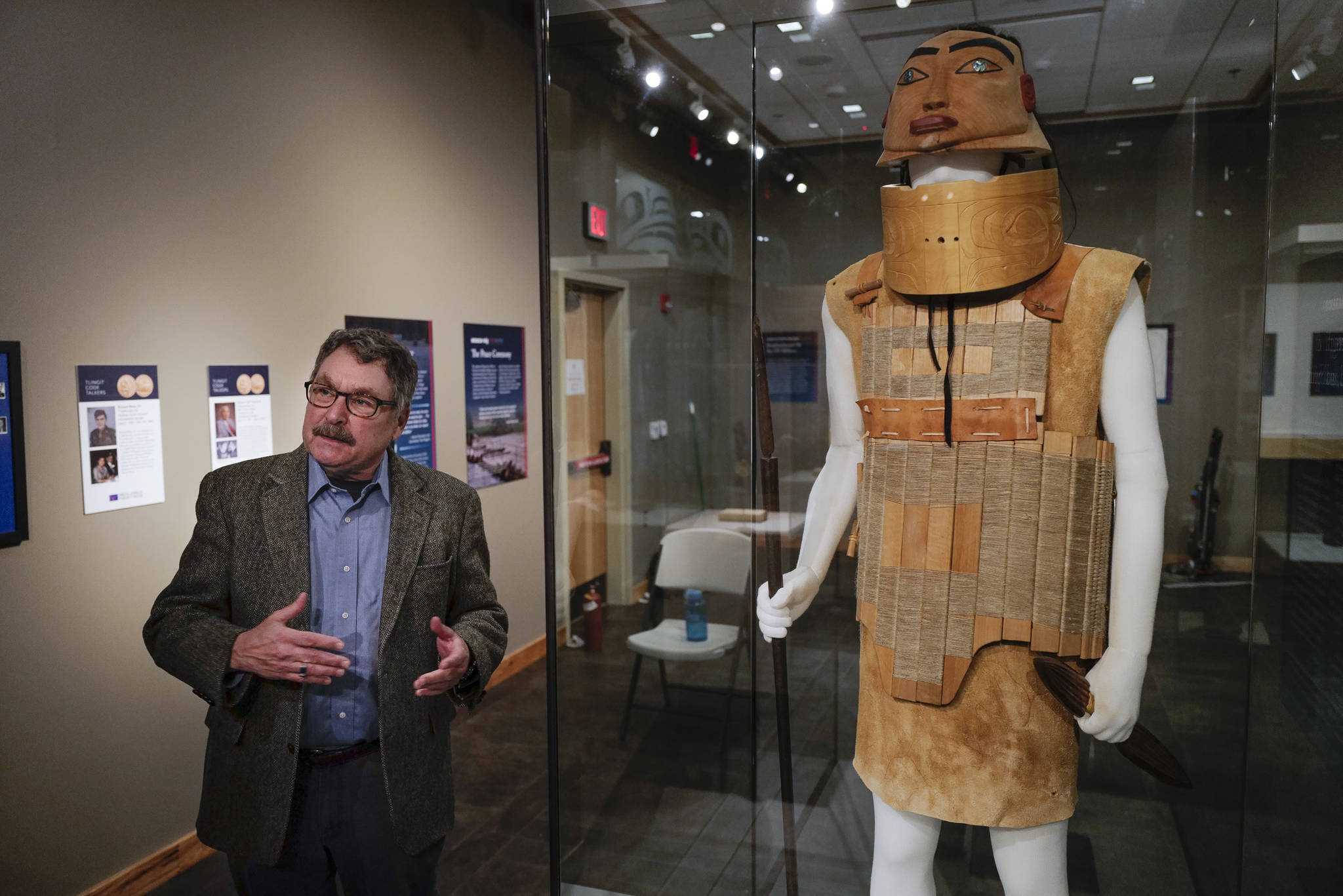 Chuck Smythe, Ph.D., History and Culture Director for Sealaska Heritage Institute, standing next to reproduction of Tlingit battle armor by Sitka artist Tommy Joseph, gives a tour of new temporary exhibit, “War & Peace” in the institute’s gallery on Friday, Dec. 6, 2019. The exhibit opens Friday, Dec. 6, for Gallery Walk and will be up until February. (Michael Penn | Juneau Empire)