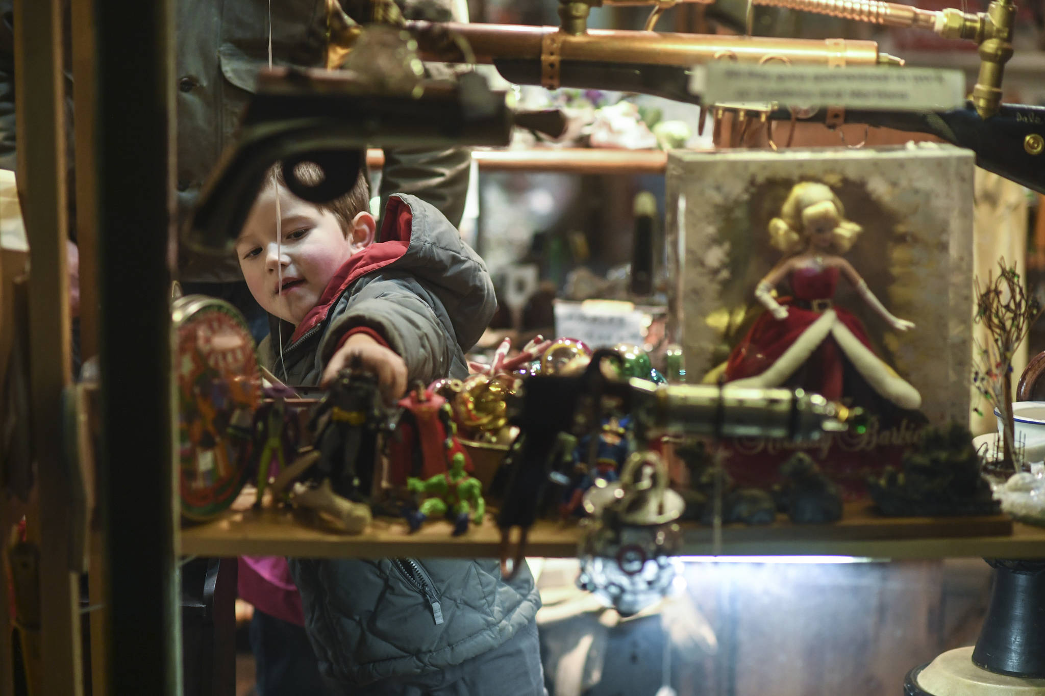 Breckett Davidson, 5, handles the toy collection at Nana’s Attic during Gallery Walk on Friday, Dec. 6, 2019. (Michael Penn | Juneau Empire)